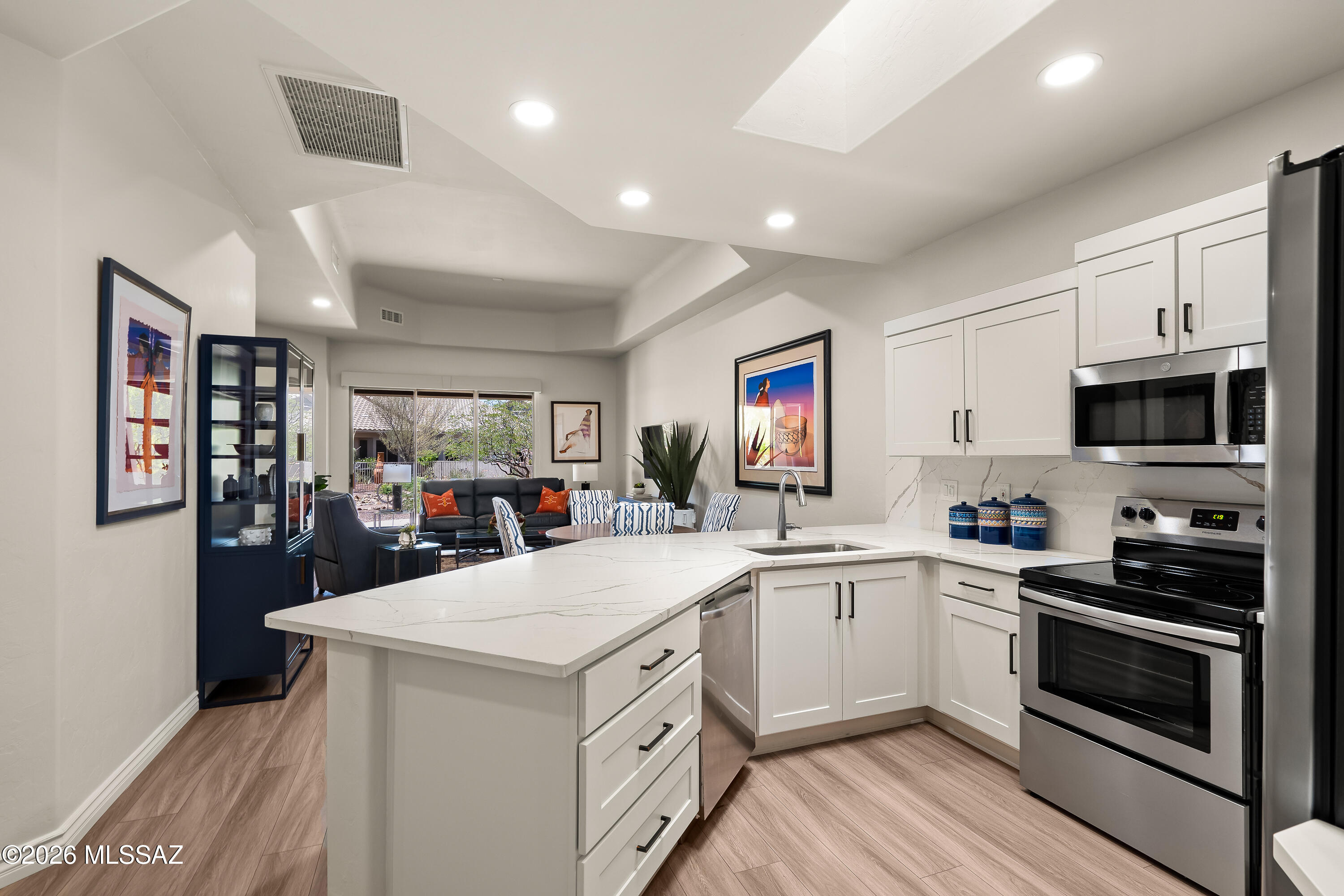 This beautifully remodeled home offers comfort, style, and low-maintenance living, nestled in 55+ Gated Community. Features include an open-concept floor plan creating an inviting atmosphere for both everyday living and entertaining. The kitchen, which boasts newer stainless-steel appliances, soft close cabinetry and stunning quartz countertops, flows seamlessly into the great room (with remote roller shade) and dining room which has tray ceilings and recessed lighting. This is a split-bedroom floor plan including a private primary suite with walk-in closet and ensuite bath. The guest bedroom also has an ensuite bath w/custom James Martin vanity. The roof, LVP flooring and ceiling fans were replaced in 2023, water heater in 2024 and HVAC in 2025. Step outside to enjoy your private patio- ideal for morning coffee or evening relaxation. Additional highlights include an attached garage, in-unit laundry, and access to community amenities; clubhouse, heated recreation and lap pool, hot tub, propane grills, fitness center with showers, card/crafts room, library, billiards, ping pong, party/dining room, full kitchen facilities, media room. The HOA dues cover an extensive list of benefits including roof repair/replacement, home exterior paint, Xfinity internet/cable TV, professional landscaping for yards and common areas, exterior insect/pest control, street maintenance and repair, water and sewer and trash/recycling plus bulk pickup.