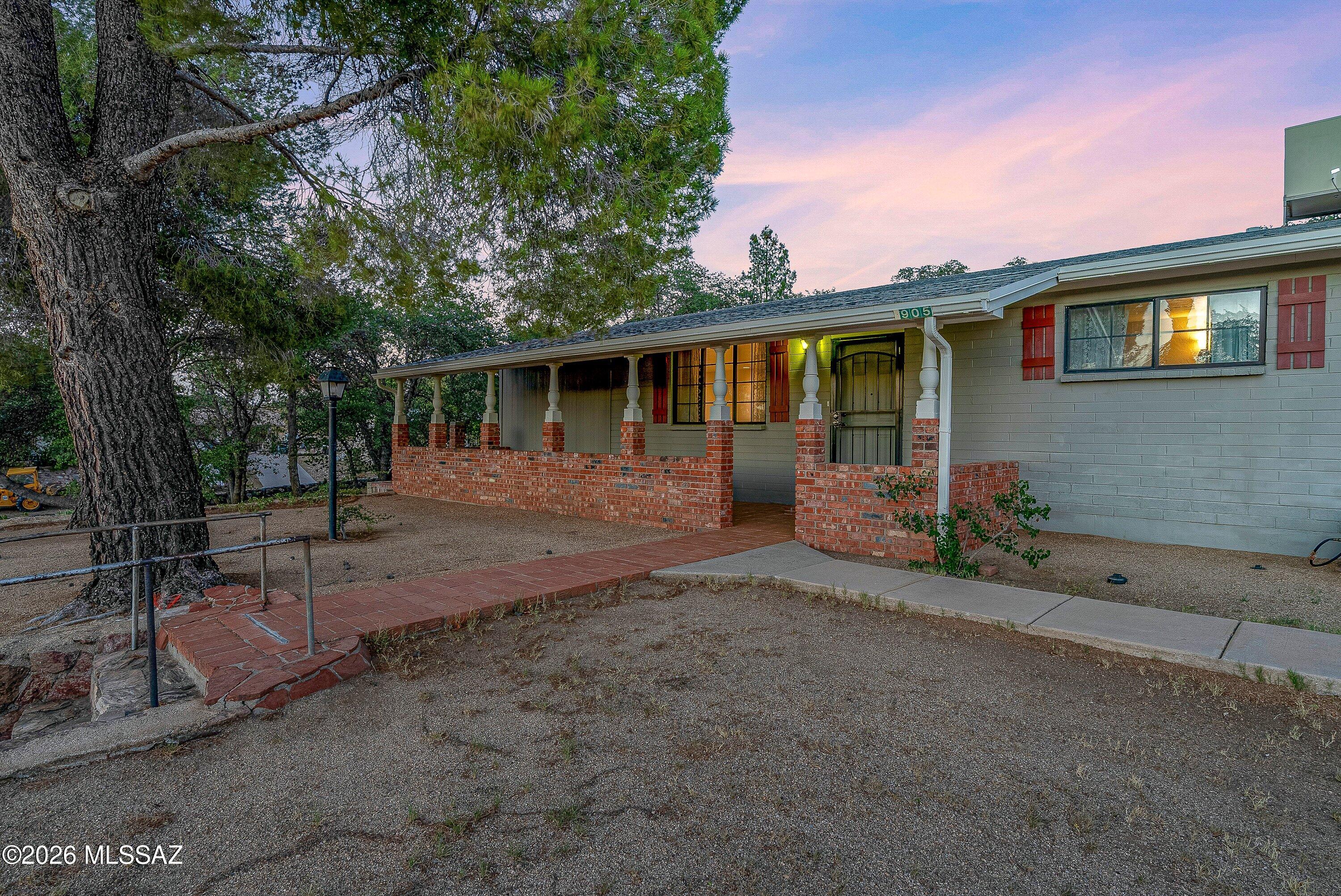 Welcome to this charming ranch-style home with a spacious covered front porch, perfect for enjoying Oracle's cooler temperatures year-round. Nestled on a large corner lot, the property is surrounded by mature evergreen and oak trees that provide abundant shade.  This well-maintained 3-bedroom, 2-bath home features easy-care tile flooring throughout. The kitchen is equipped with all brand-new appliances, making it move-in ready. The fenced backyard offers plenty of space for pets, play, or entertaining and includes an oversized RV carport. Adjacent to the carport is an impressive workshop that provides endless possibilities. Ample parking for multiple vehicles, RVs, or visiting guests. This inviting home combines comfort, functionality, and small-town charm.
