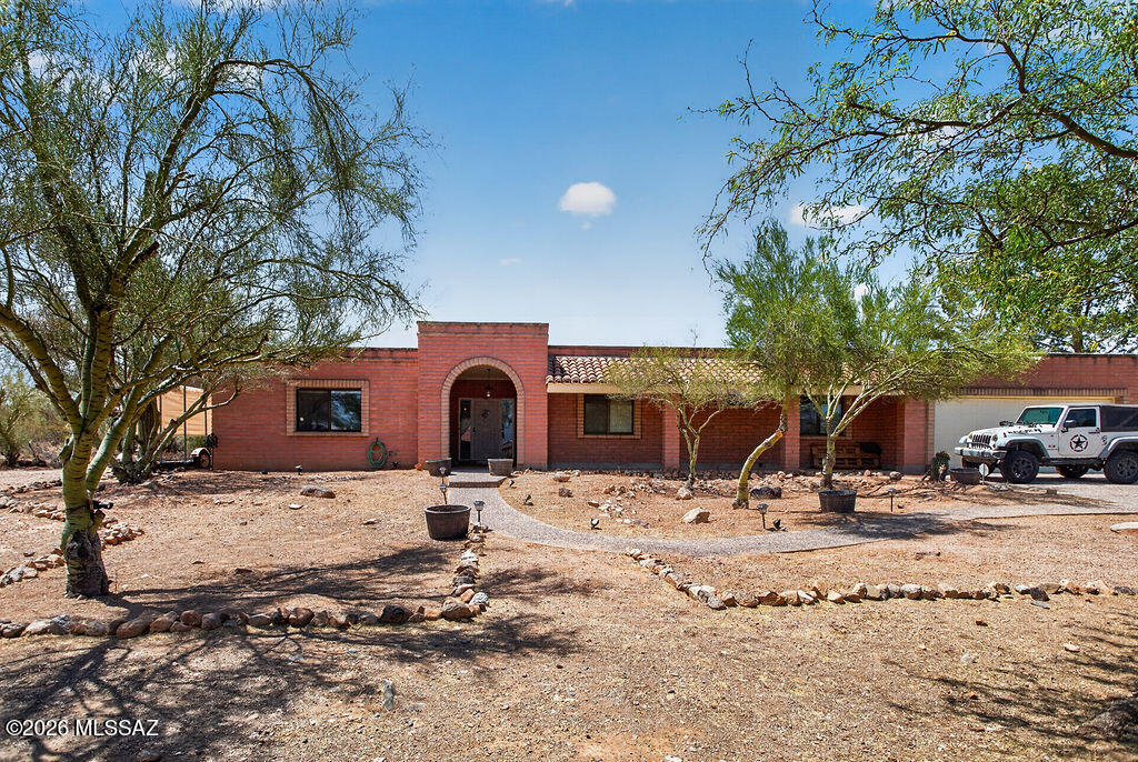 List range pricing $650k-$725k.
Set on a desirable 1.15 acre lot with no HOA and room for horses, this property offers space, privacy, and true Arizona living. This home features 2,714 square feet with 4 bedrooms, 4 bathrooms. 
 The land features beautiful natural desert landscaping with mature trees and saguaros, plus a fully enclosed backyard with both a side gate and double gate access. Outside, enjoy the sparkling pool surrounded by brick pavers, a raised patio for lounging, a large grass turf area and includes gutters that feed into two water cisterns. 
The property offers exceptional parking and storage: Slump block construction with an oversized 2 car garage that features an attached workshop, a detached 2 car carport, plus covered RV parking. The long aggregate driveway allows for additional parking. There's plenty of room for all your toys--bring your boat, RV, or even your horses! You are greeted with an oversized front covered porch with an arched entryway. 
The spacious foyer opens to the living room with a wood burning fireplace. Ceiling fans and wood cased doorways throughout, plus a custom barn door in the formal dining room. The kitchen includes a breakfast nook, abundant cabinetry, and opens to the family room (or dining room!). Two sets of French doors lead to the enclosed Arizona room, complete with wood plank ceilings, Anderson windows that overlook the pool in the backyard, ceiling fans, and a convenient powder bath--perfect for those pool days! The primary suite features a walk in closet, ceiling fan, double sink vanity with updated brushed nickel fixtures, and a beautifully remodeled shower with decorative tile, pebble flooring, and dual shower heads. Two additional bathrooms have been fully remodeled with custom wood cabinetry, quartz countertops, modern lighting, decorative tile surrounds, and thoughtful storage. A spacious laundry room adds even more convenience. 
Additional features include: 
Water softener 
Roof recently recoated with warranty