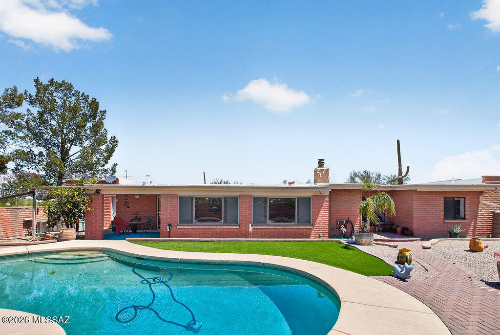 Set on a desirable 1.15 acre lot with no HOA and room for horses, this property offers space, privacy, and true Arizona living. This home features 2,714 square feet with 4 bedrooms, 4 bathrooms. 
 The land features beautiful natural desert landscaping with mature trees and saguaros, plus a fully enclosed backyard with both a side gate and double gate access. Outside, enjoy the sparkling pool surrounded by brick pavers, a raised patio for lounging, a large grass turf area and includes gutters that feed into two water cisterns. 
The property offers exceptional parking and storage: Slump block construction with an oversized 2 car garage that features an attached workshop, a detached 2 car carport, plus covered RV parking. The long aggregate driveway allows for additional parking. This property has space to conveniently drive your RV straight through. There's plenty of room for all your toys--bring your boat, RV, or even your horses! You are greeted with an oversized front covered porch with an arched entryway. 
The spacious foyer opens to the living room with a wood burning fireplace. Ceiling fans and wood cased doorways throughout, plus a custom barn door in the formal dining room. The kitchen includes a breakfast nook, abundant cabinetry, and opens to the family room (or dining room!). Two sets of French doors lead to the enclosed Arizona room, complete with wood plank ceilings, Anderson windows that overlook the pool in the backyard, ceiling fans, and a convenient powder bath--perfect for those pool days! The primary suite features a walk in closet, ceiling fan, double sink vanity with updated brushed nickel fixtures, and a beautifully remodeled shower with decorative tile, pebble flooring, and dual shower heads. Two additional bathrooms have been fully remodeled with custom wood cabinetry, quartz countertops, modern lighting, decorative tile surrounds, and thoughtful storage. A spacious laundry room adds even more convenience. 
Additional features include: 
 10x20 pool house shed with electrical outlet
 Water softener 
Roof recently recoated with warranty 
Newer Water heater