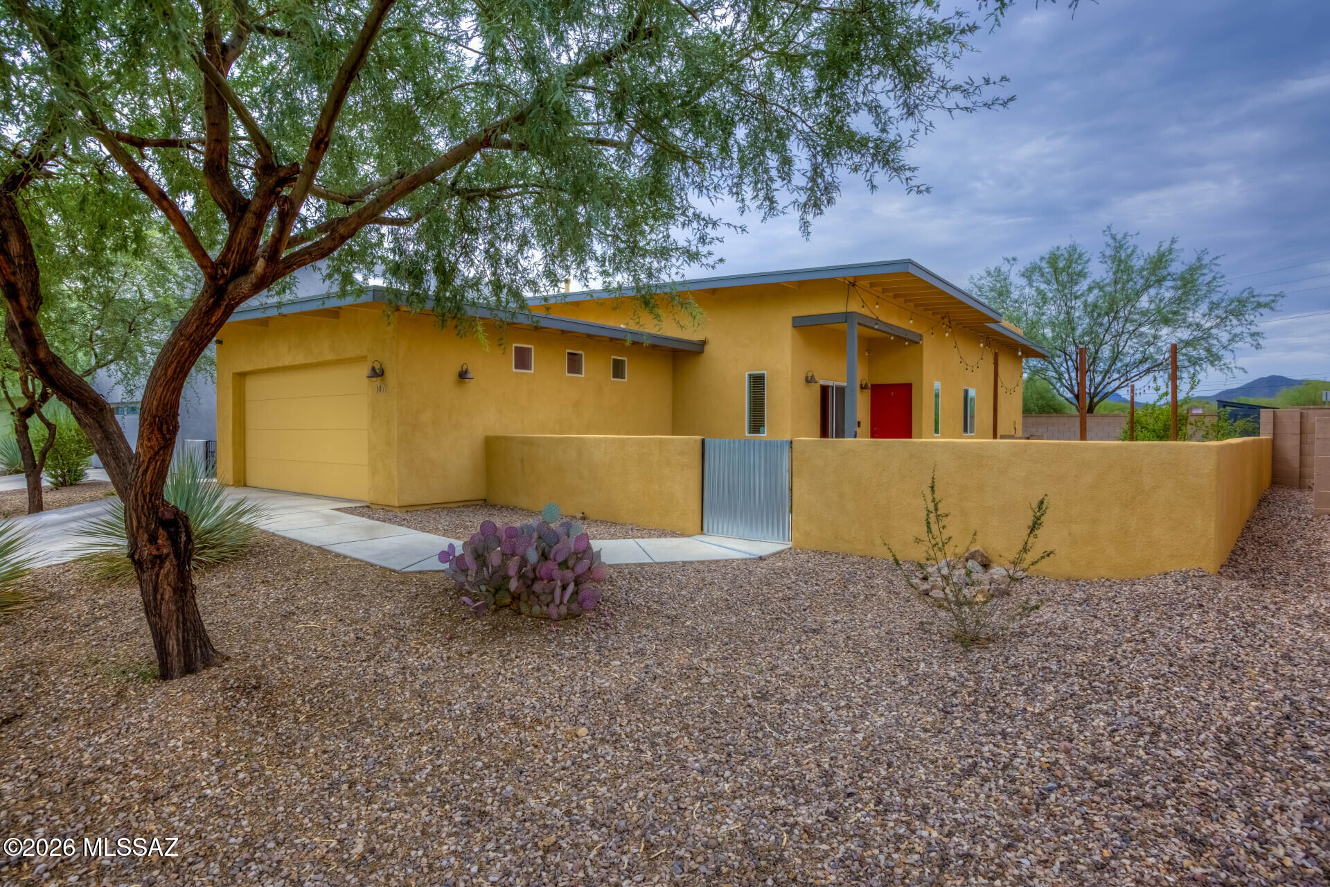 Amazing modern open concept 3 bd/2b in desirable Westside, close to downtown, U of A, Pima College, bike loop, hiking trails, shopping/restaurants and more! This upgraded former model has a full chef's kitchen w/ white cabinets, stainless appliances, double ovens, refrigerator (2025), microwave (2025), dishwasher (2023), large stone island, large tile flooring.  Master includes walk-in closet, spacious tiled shower, double sinks, 2 additional bedrooms (one being used as office), guest bath w/ tub.  Outside enjoy fully fenced yard with 2 separate entertaining spaces, including a private, extended covered  back porch (home backs to open space), mature shade/fruit trees, new irrigation system (2026).  Bonus- gardener's dream with raised stone garden bed and storage shed. Must see!!