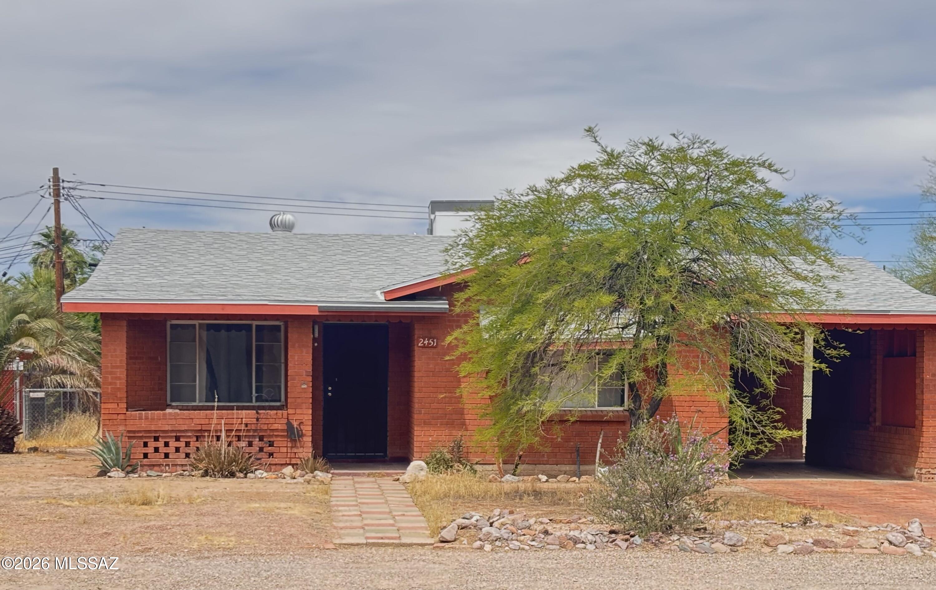 Quaint, mid-century, wire-cut brick ranch with curb appeal that delivers! Tiled windowsills and niches offer classic charm. BRAND NEW roof, HVAC, and main electrical panel along with an updated bathroom provide extra confidence for years to come! All this coupled with consistent tile floors throughout, sizable kitchen, and well-proportioned living area and bedrooms makes 2451 N Richey Blvd a delightful nugget and excellent: starter home, place to downsize, or worthy investment property. Not convinced yet?? There's more to see here...large workshop offers convenient storage, handy person haven, or other useful space. One generously sized parcel with two assigned addresses and R-2 zoning = potential ADU opportunity! Owning this midtown gem also provides easy access to: UA and many other locations, public transportation, metal arts village, Rillito Riverwalk, parks, shops and restaurants. This isn't one to skip...see for yourself and make it yours!