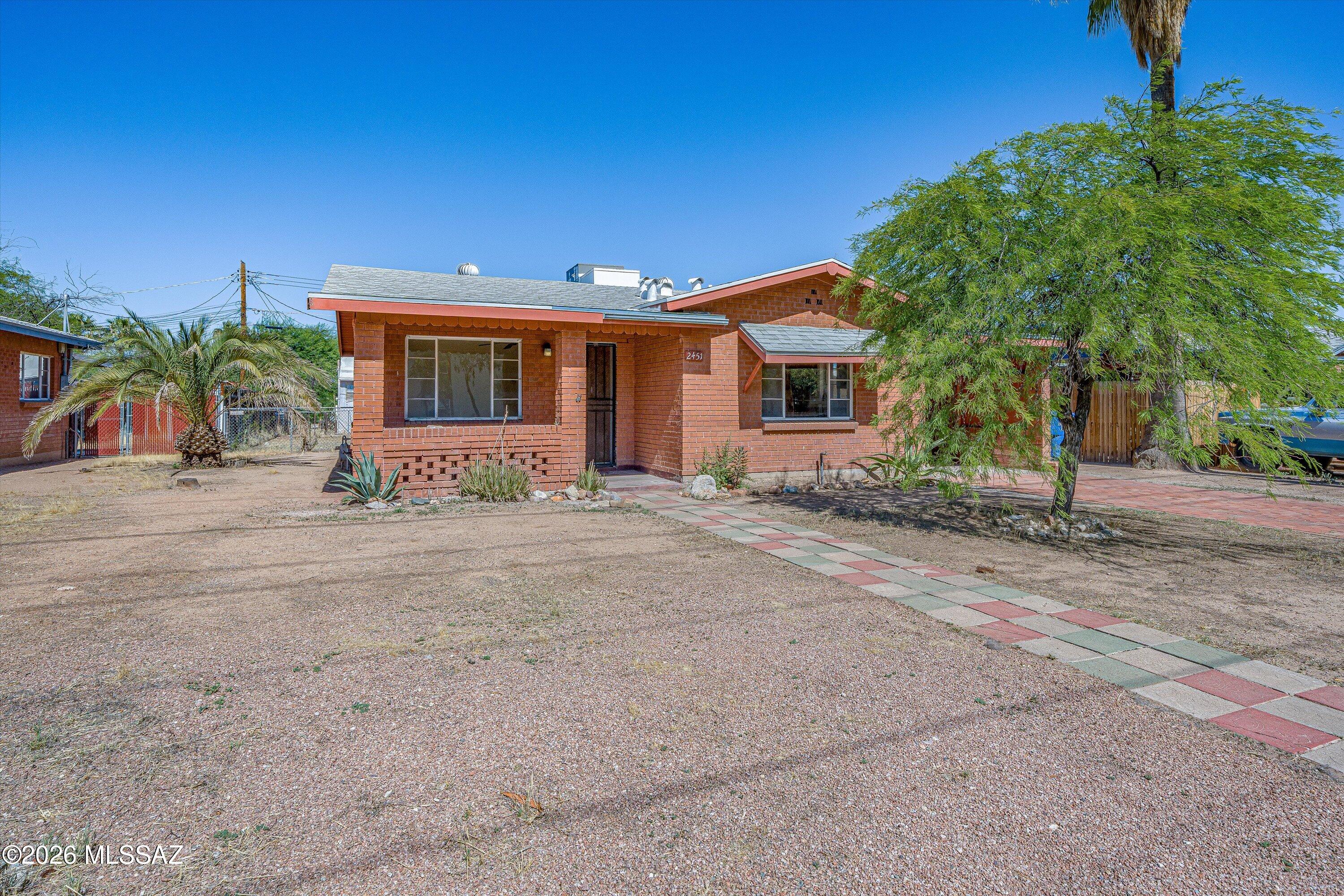 Quaint, mid-century, wire-cut brick ranch with curb appeal that delivers! Tiled windowsills and niches offer classic charm. BRAND NEW roof, HVAC, and main electrical panel along with an updated bathroom provide extra confidence for years to come! All this coupled with consistent tile floors throughout, sizable kitchen, and well-proportioned living area and bedrooms makes 2451 N Richey Blvd a delightful nugget and excellent: starter home, place to downsize, or worthy investment property. Not convinced yet?? There's more to see here...large workshop offers convenient storage, handy person haven, or other useful space. One generously sized parcel with two assigned addresses and R-2 zoning = potential ADU opportunity! Owning this midtown gem also provides easy access to: UA and many other locations, public transportation, metal arts village, Rillito Riverwalk, parks, shops and restaurants. This isn't one to skip...see for yourself and make it yours!