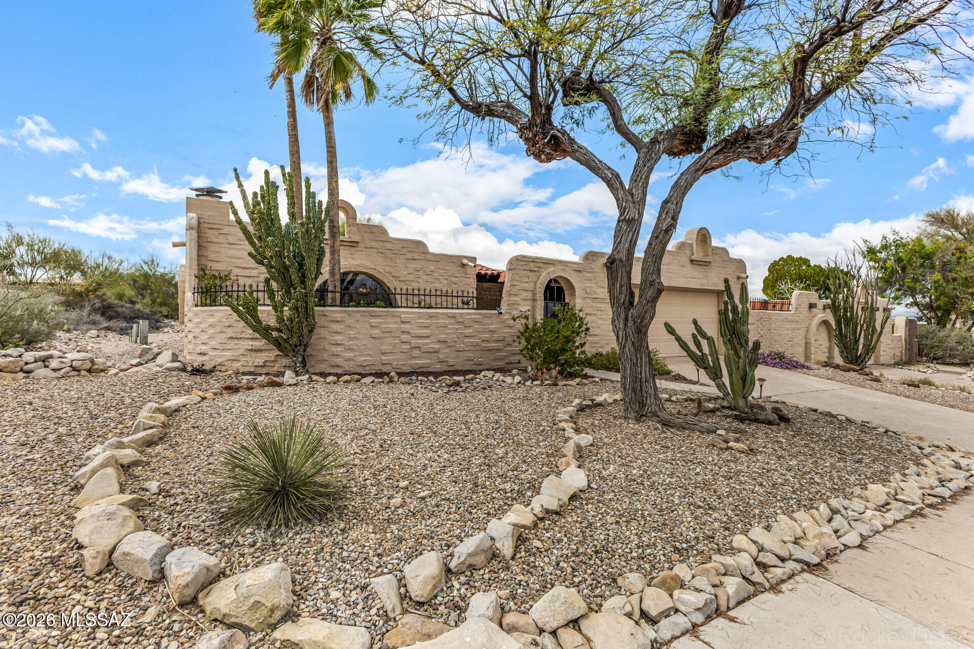 Beautiful Southwestern-style home featuring classic adobe architecture, charming courtyard entry, and low-maintenance desert landscaping. Inside, the spacious open floor plan offers abundant natural light, large living areas, and distinctive architectural features including a stunning beehive fireplace and arched windows.

The kitchen is centrally located and includes extensive cabinetry, tile countertops, breakfast bar seating, and a skylight that fills the space with natural light. The kitchen opens seamlessly to the main living areas, making it ideal for entertaining.

Generous living spaces feature tile flooring throughout, large sliding doors to the covered patio, and views of the private backyard. The outdoor space includes a covered patio, mature desert landscaping, and plenty of room to relax or entertain.

The home also offers spacious bedrooms, a walk-in closet, and comfortable bathrooms with tile surrounds.

Conveniently located near shopping, dining, and outdoor recreation, this property blends classic Southwestern charm with comfortable living.