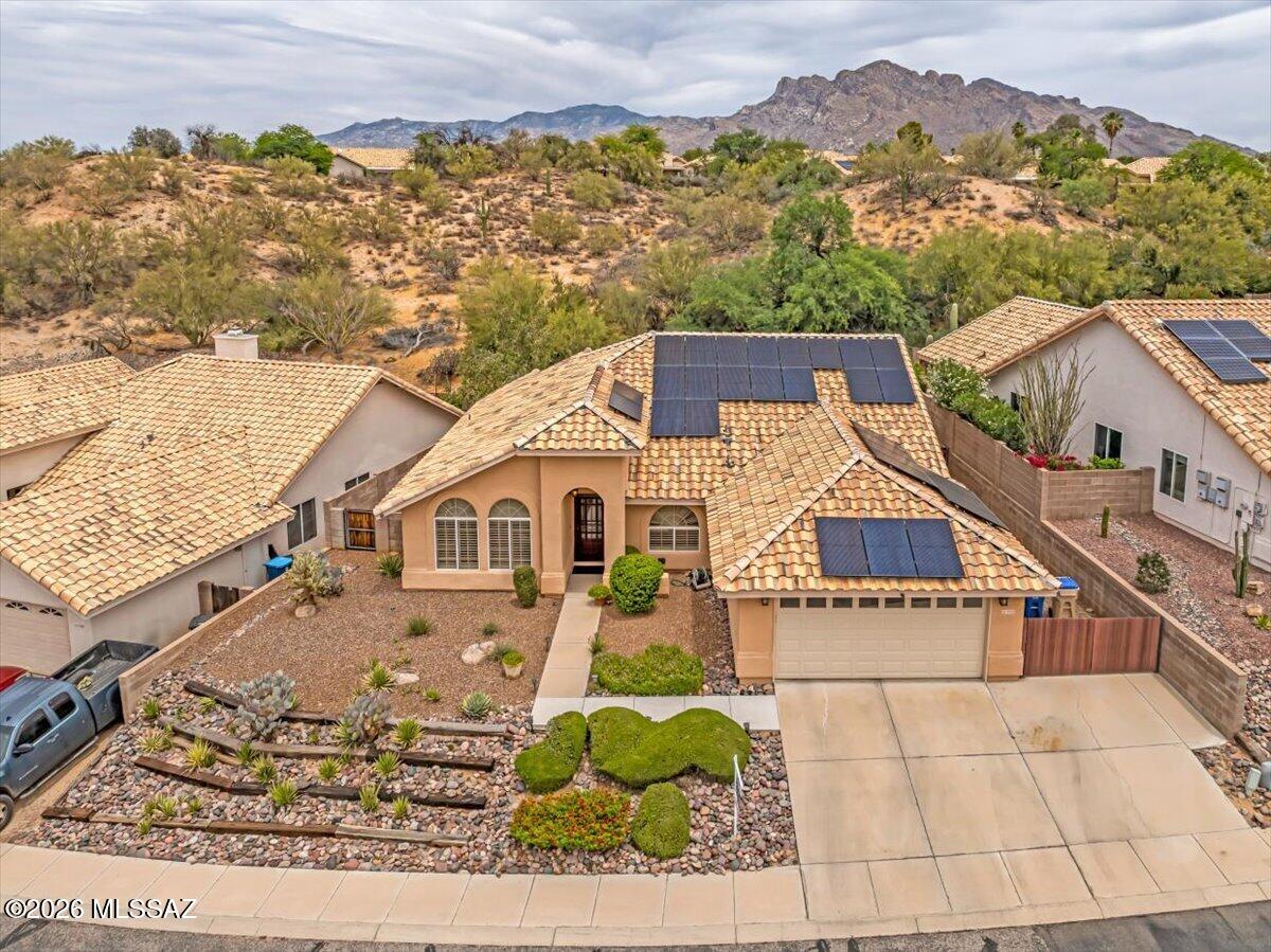 Original owner and meticulously maintained, this spacious single-story home offers 1,945 SqFt with 3 bedrooms + a versatile den with closet that can easily serve as a 4th bedroom, 2 bathrooms, and a 2-car garage. Built in 1990, this move-in ready home showcases pride of ownership throughout with soaring ceilings, abundant natural light, and exceptional storage space throughout the home.
Enjoy energy-efficient living in this all-electric home featuring leased solar installed in 2022, resulting in nearly $0 electric bills, along with a newer A/C (approx. 3 years old) and roof replacement completed in 2021. Step outside to your own private desert retreat featuring low care landscaping, a Pebble Tec pool, hot tub, double gate access, and open desert directly behind the property. A private man gate leads straight to nearby hiking trails, offering the perfect blend of privacy, nature, and outdoor living. The beautifully secluded backyard is ideal for relaxing or entertaining under Tucson's stunning skies.