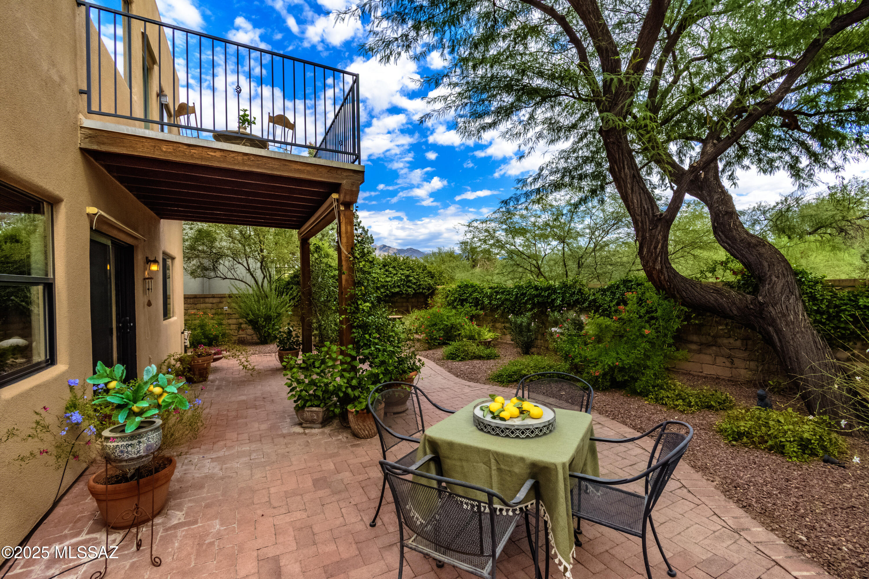 Situated in the HEART of Ft Lowell Historical District, this hidden gem is nestled w/i coveted gated Barrio Del Este, an intimate enclave of homes on a secluded, private cul-de-sac. Adj to an enchanting trail along the Alamo Wash leading directly to the 130-mile Tucson Loop Trail - Great walking & cycling. Exposed adobe walls within lush front courtyard. Spacious 4 bdrms, +office,+ loft- flex spaces. Features: Soaring viga beamed ceilings, artistic custom security gate, clerestory windows/natural light. Gas fireplace. Expansive covered patio & balcony w/ stunning Catalina Mtn views overlooking natural area. Open kitchen concept with gas range/ss appliances & walk-in pantry. 2 car garage. Drip Irrigation. Walk to shopping & restaurants at Plaza Palomino. Near schools & parks.