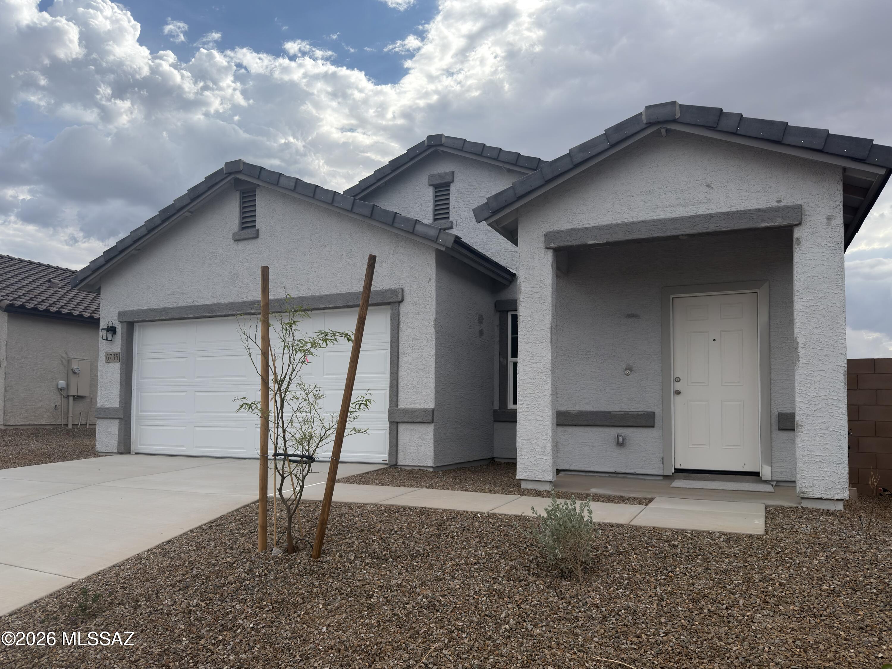 Our Sterling plan sits right across from the park area with great views and beautiful sunsets!  3 Bedrooms and 2 Baths make this quaint home a charmer!  Large island in the kitchen too!  Beautiful, brand-new homes featuring thoughtfully designed floorplans in the scenic Tucson community of Star Valley! Conveniently located with easy access to I-19 and major Tucson destinations, this community offers the perfect balance of comfort, convenience, and outdoor living. Homes showcase desirable upgrades including 9' ceilings, white shaker cabinets, Shaw 17'' x 17'' tile flooring, and granite kitchen countertops. Each home comes move-in ready with stainless steel kitchen appliances, including a refrigerator, washer, and dryer. Energy-efficient features include Low-E dual-pane windows and a Wi-Fi programmable thermostat to help maximize comfort and savings. Exterior highlights include front yard desert landscaping with irrigation, covered patios, and spacious backyards designed for enjoying Tucson's beautiful sunsets. Residents enjoy community amenities including large park with soccer fields; walking paths and natural trails; children's play area; basketball courts; tennis courts; pickleball courts; natural-area dog park and incredible mountain views everywhere! This welcoming community offers the perfect combination of modern living and the natural beauty of the Tucson desert.
