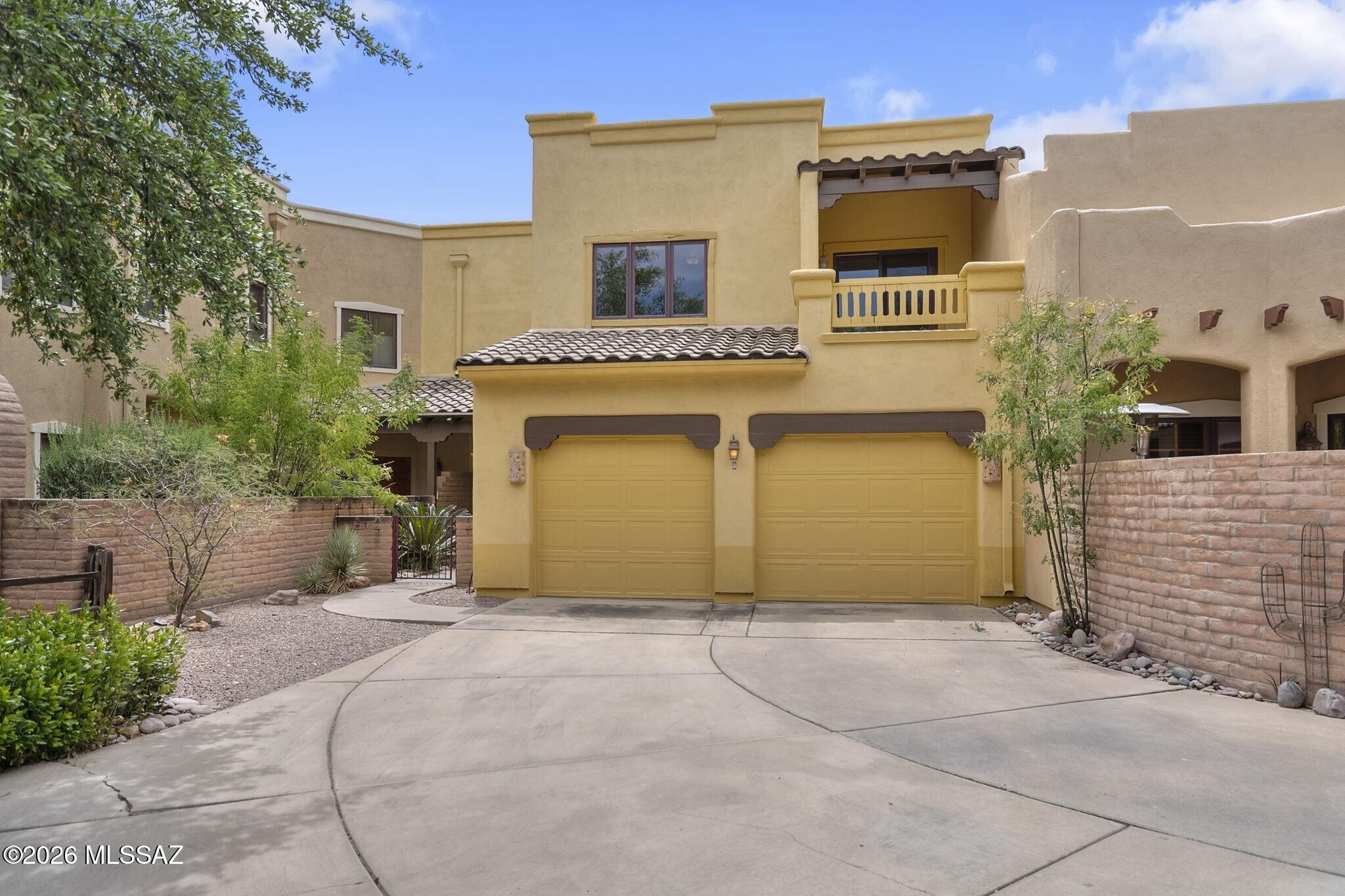 Set within the sought-after Barrio Cielito Lindo de Tubac, this spacious and elegant townhome offers low-maintenance living amid elevated design elements. Outdoor space includes a courtyard terrace offering panoramic mountain vistas. Interior layout features two spacious primary suites on the upper level, each with its own private balcony. Open-concept main level gathering space includes living room with cozy fireplace, dining room with direct terrace access, and generous kitchen with tile backsplash and live-edge wood bar. Dual-bay garage provides additional convenience. HOA covers exterior paint, street maintenance and community pool. Located just moments from the Historic Art Village of Tubac, you'll enjoy easy access to galleries, restaurants, boutiques and Presidio Historic Park.