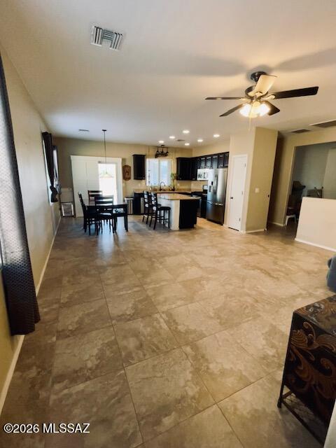Beautifully upgraded home featuring rich Crown Royal cabinetry, granite countertops, and stainless steel appliances. The desirable split floor plan offers 3 bedrooms plus a den, providing flexibility for a home office, hobby room, or additional living space. Elegant 18-inch tile flooring runs throughout the main living areas, with carpet in two of the guest bedrooms for added comfort. The spacious primary suite includes a large walk-in closet with custom shelving, a separate shower, and a relaxing jetted Jacuzzi tub. Enjoy the extra-large backyard with endless possibilities for outdoor entertaining, play areas, gardening, or even a future pool.  HVAC replaced May 2024