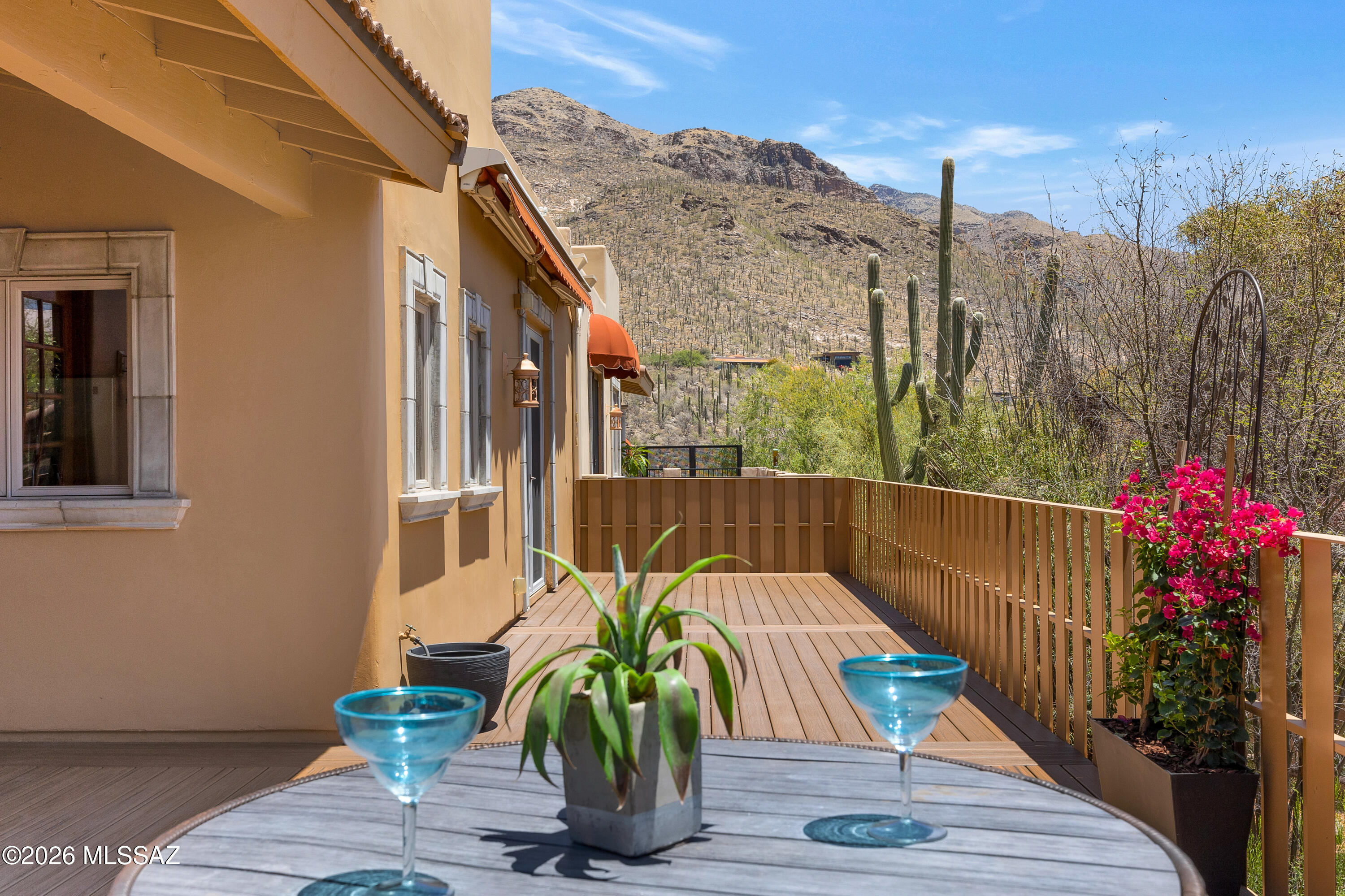 Gorgeous Mediterranean 2BD/2.5BA townhome in gated Villa Milano at Sin Vacas, offering mountain views from both the front & back. This move-in-ready, single-story Foothills home features high ceilings, split dual-primary floor plan, distinctive character + luxe finishes. Highlights include  8' alder doors, granite counters, beautiful wood cabinets, travertine in main living areas & brand-new engineered wood flooring in bedrooms. Owner's suite offers large walk-in closet, separate shower, and jetted tub & French doors to a new deck w/mountain views. The guest suite also features a walk-in closet & en-suite bath. Abundant storage throughout! Enjoy community pool in this no-rental community--perfect for year-round living or winter visitors. Close to everything the  Foothills have to offer.