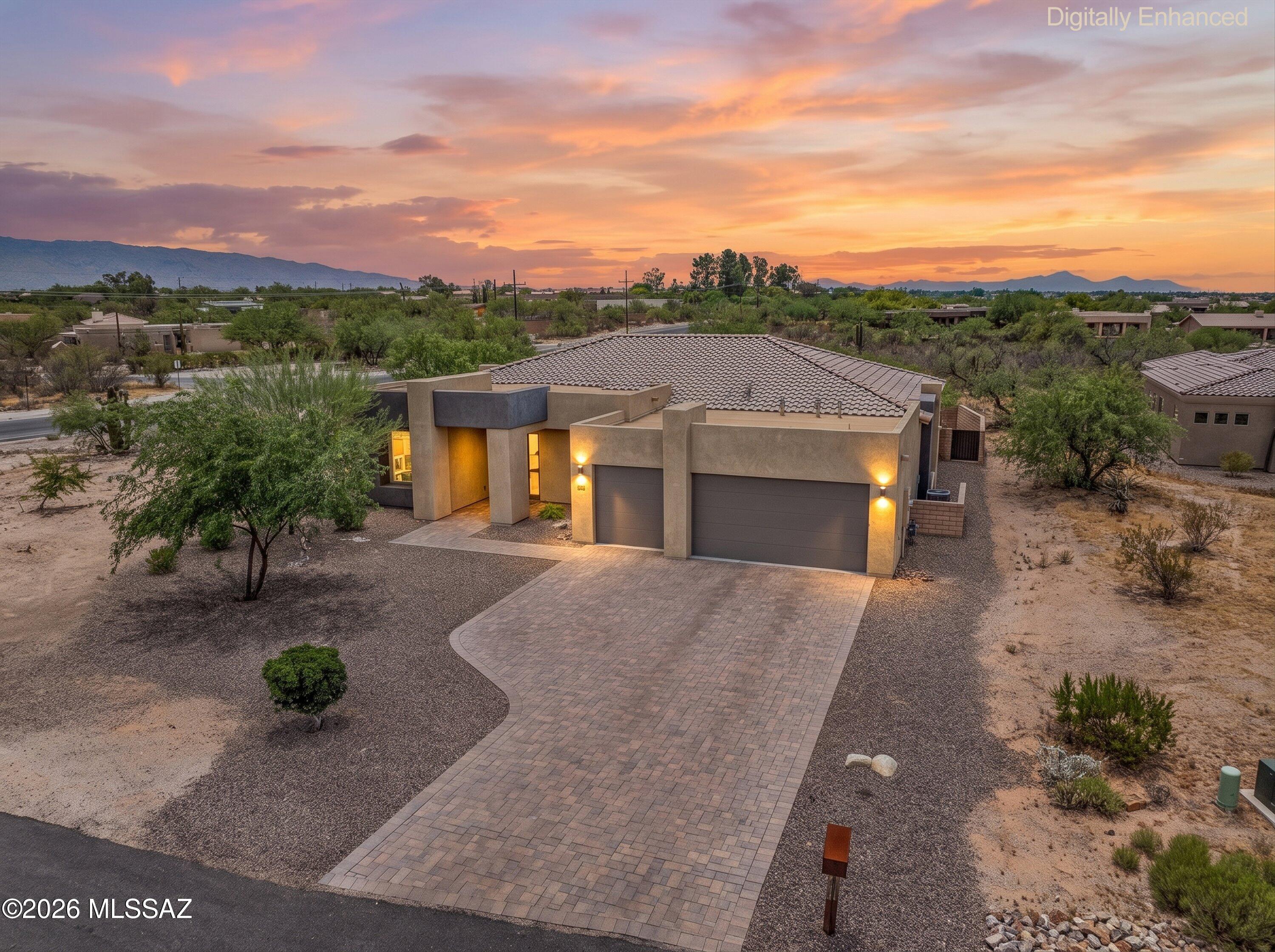 Gorgeous 4BED/3BATH former model home in the highly sought-after Bear Canyon/Tanque Verde area! Loaded with premium builder upgrades, this stunning home welcomes you with a paver driveway, elegant frosted glass French entry doors and 3-car garage. Inside you'll find soaring ceilings, abundant natural light, and a spacious open-concept layout to create an inviting atmosphere. The gourmet kitchen is the heart of the home featuring a large granite island with bar seating, quartz countertops, stainless steel appliances, a gas cooktop with hood and wood cabinetry. Warm neutral finishes, wood-look ceramic tile, and carpet throughout. The split-bedroom floor plan offers added privacy, while the owner's suite features a dual quartz vanity, soaking tub, walk-in shower and oversized walk-in closet. Expansive sliding glass doors open to the beautifully landscaped backyard, perfect for indoor-outdoor living. Outside backyard is a dream with an extended paver patio, artificial turf, mature desert landscaping, and plenty of space to relax or entertain. Additional highlights include a whole-home water softener, reverse osmosis system and automated window shades for select few windows. Enjoy breathtaking Catalina Mountain views and Desert views. Don't miss out on this gem!