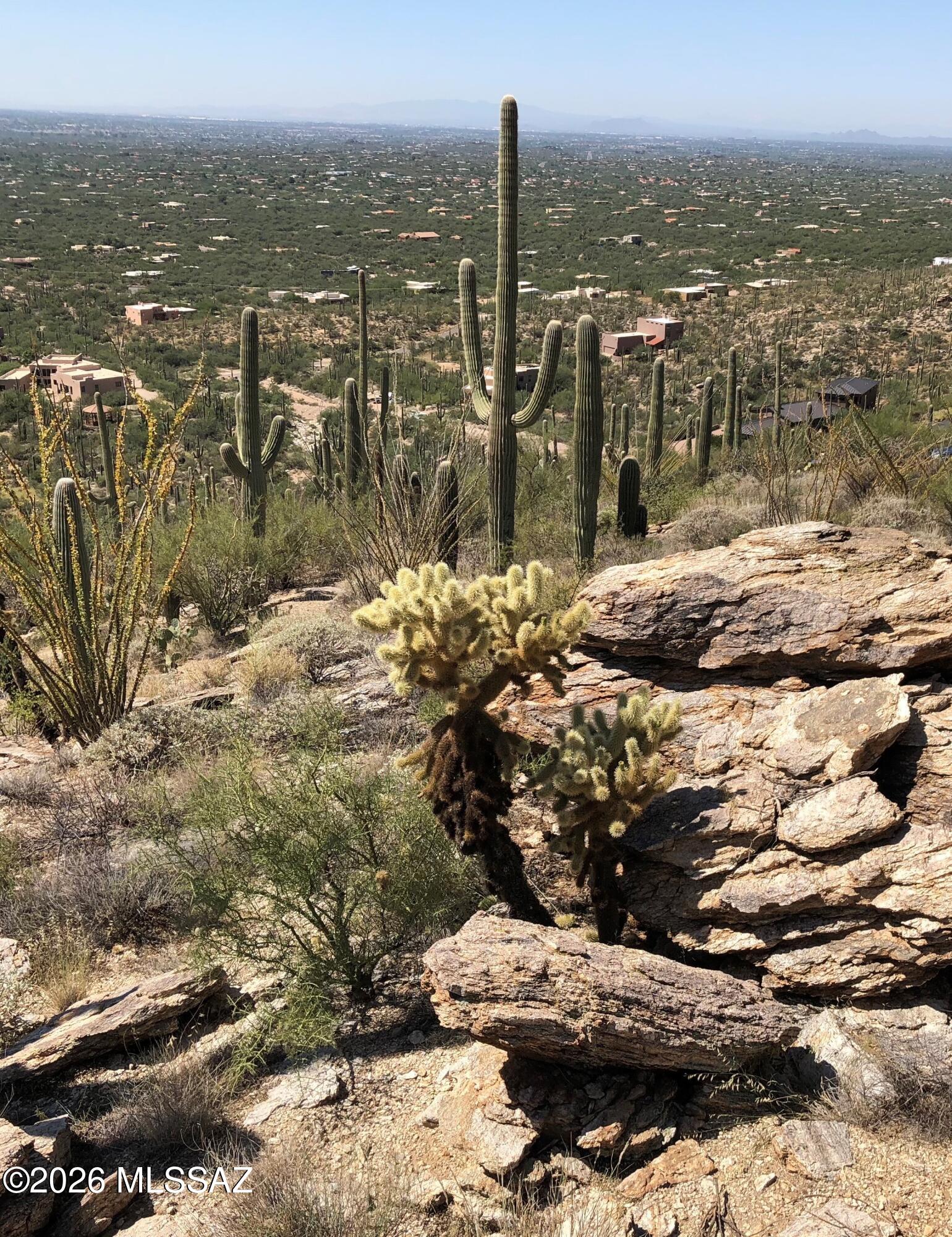 Experience some of the most breathtaking panoramic views in the Tucson Valley--at a price that's hard to match. Nestled at the base of Mt. Lemmon on over 3 acres, this exceptional homesite is one of the highest custom lots available on Tucson's northeast side.
Follow the driveway to a partially graded building site and envision your dream home surrounded by stunning natural beauty. Thoughtful placement of your future residence can capture sweeping vistas of the Tucson city lights, dramatic canyon views at the rear of the property, and spectacular mountain ranges in every direction. Utilities are conveniently available, underground electric and Water located at the road. Located within the highly acclaimed Tanque Verde School District and free from HOA restrictions.