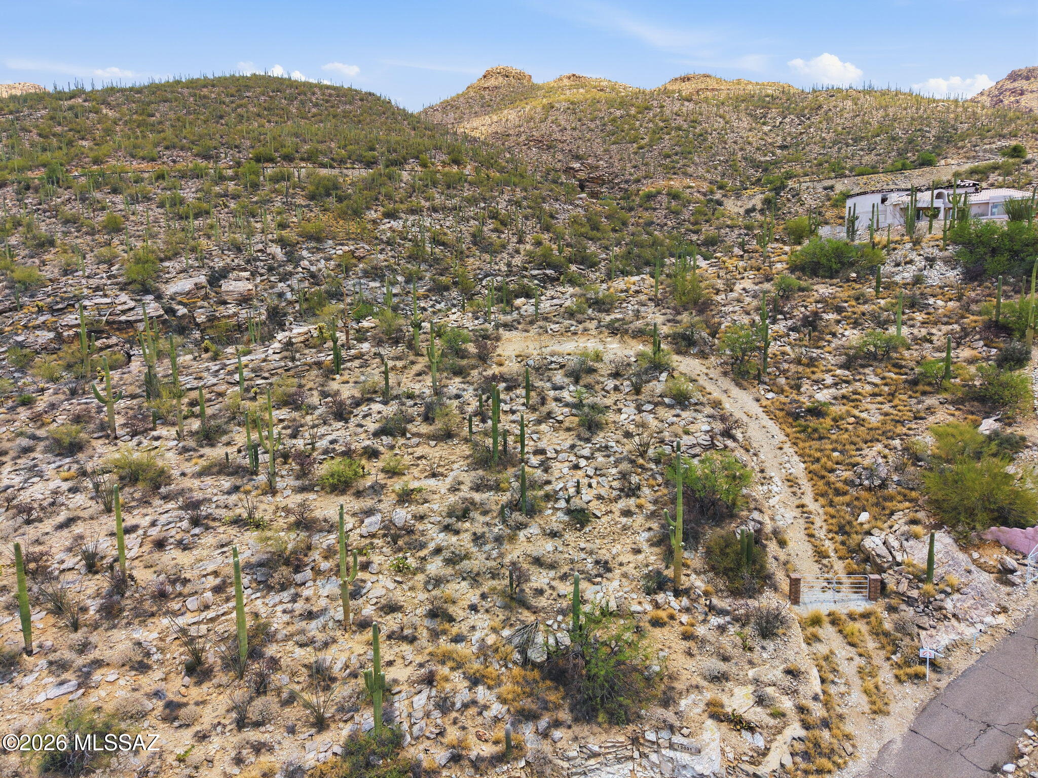 Experience some of the most breathtaking panoramic views in the Tucson Valley--at a price that's hard to match. Nestled at the base of Mt. Lemmon on over 3 acres, this exceptional homesite is one of the highest custom lots available on Tucson's northeast side.
Follow the driveway to a partially graded building site and envision your dream home surrounded by stunning natural beauty. Thoughtful placement of your future residence can capture sweeping vistas of the Tucson city lights, dramatic canyon views at the rear of the property, and spectacular mountain ranges in every direction. Utilities are conveniently available, underground electric and Water located at the road. Located within the highly acclaimed Tanque Verde School District and free from HOA restrictions.