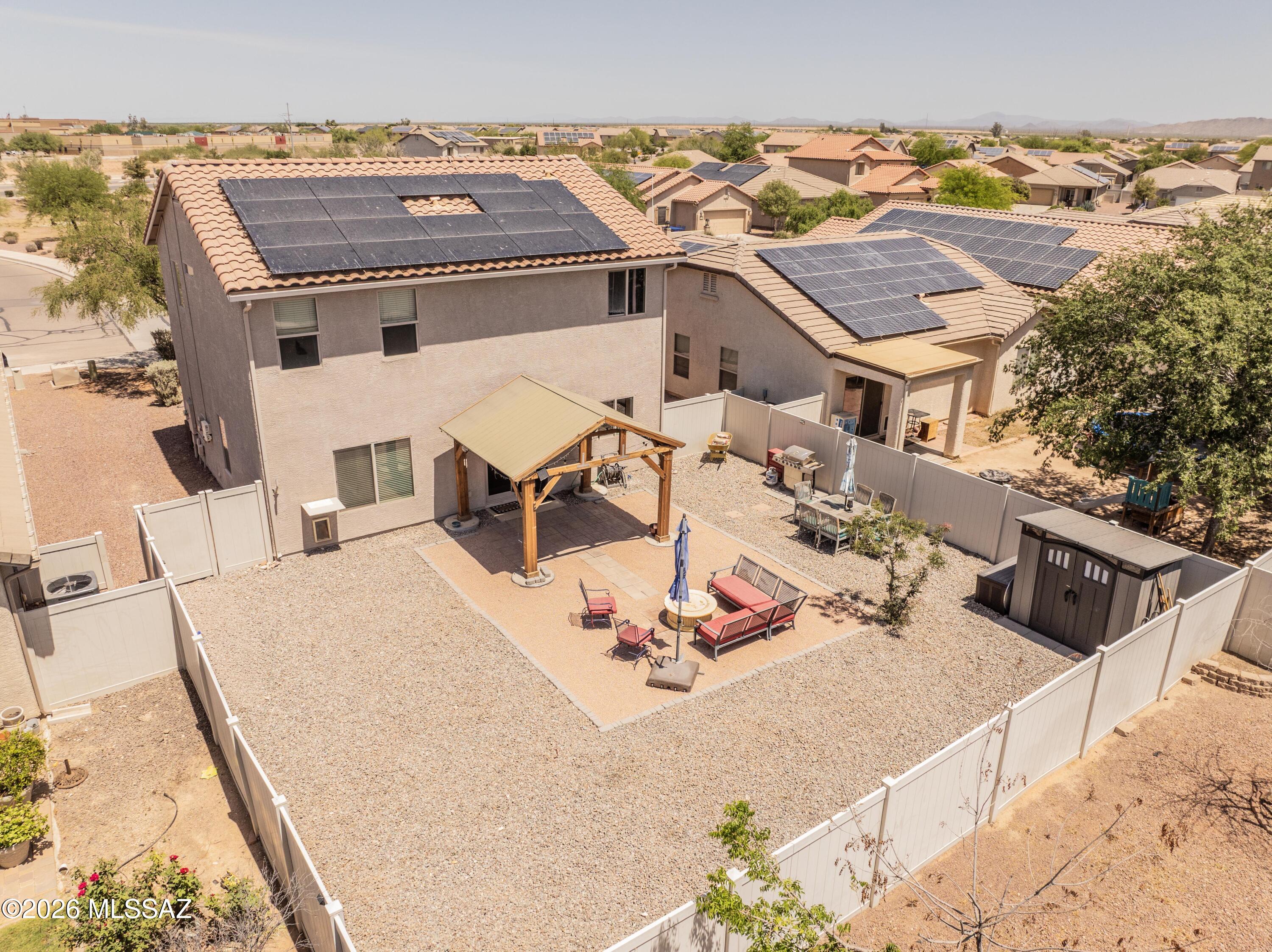 Beautiful, energy-efficient home in the desirable Red Rock Village community! This spacious 3 bed, 3 bath home offers great features throughout, including free-and-clear solar, an EV garage charging station, dual-pane windows, water heater & A/C unit less than 5 years old. The kitchen is equipped with stainless steel appliances, including a 4-door refrigerator that conveys. Upstairs offers a versatile loft perfect for additional living space, a home office, or flex area. French doors lead to a landscaped backyard featuring a new covered patio with shade screens, pavers, and a seating area with a fire pit ideal for relaxing Arizona evenings and entertaining. Many furniture items throughout the home and backyard, including a new Samsung washer and dryer set, are available with an acceptable offer or on a separate bill of sale. Don't miss all the community amenities, including a swimming pool, skate park, basketball courts, baseball fields, volleyball courts, and more.