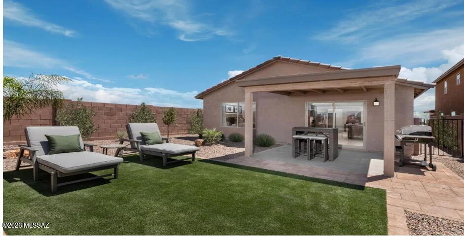 Former model home boasts front and back yard landscaping, designer art and window treatments, 12x24 porcelain tile in all rooms except bedrooms. The kitchen features Silestone® countertops with tile backsplash, and Whirlpool® stainless steel appliances. Covered back patio with views of the Rincon Mountains. Price includes discount predicated on using seller's preferred lender KBHS.