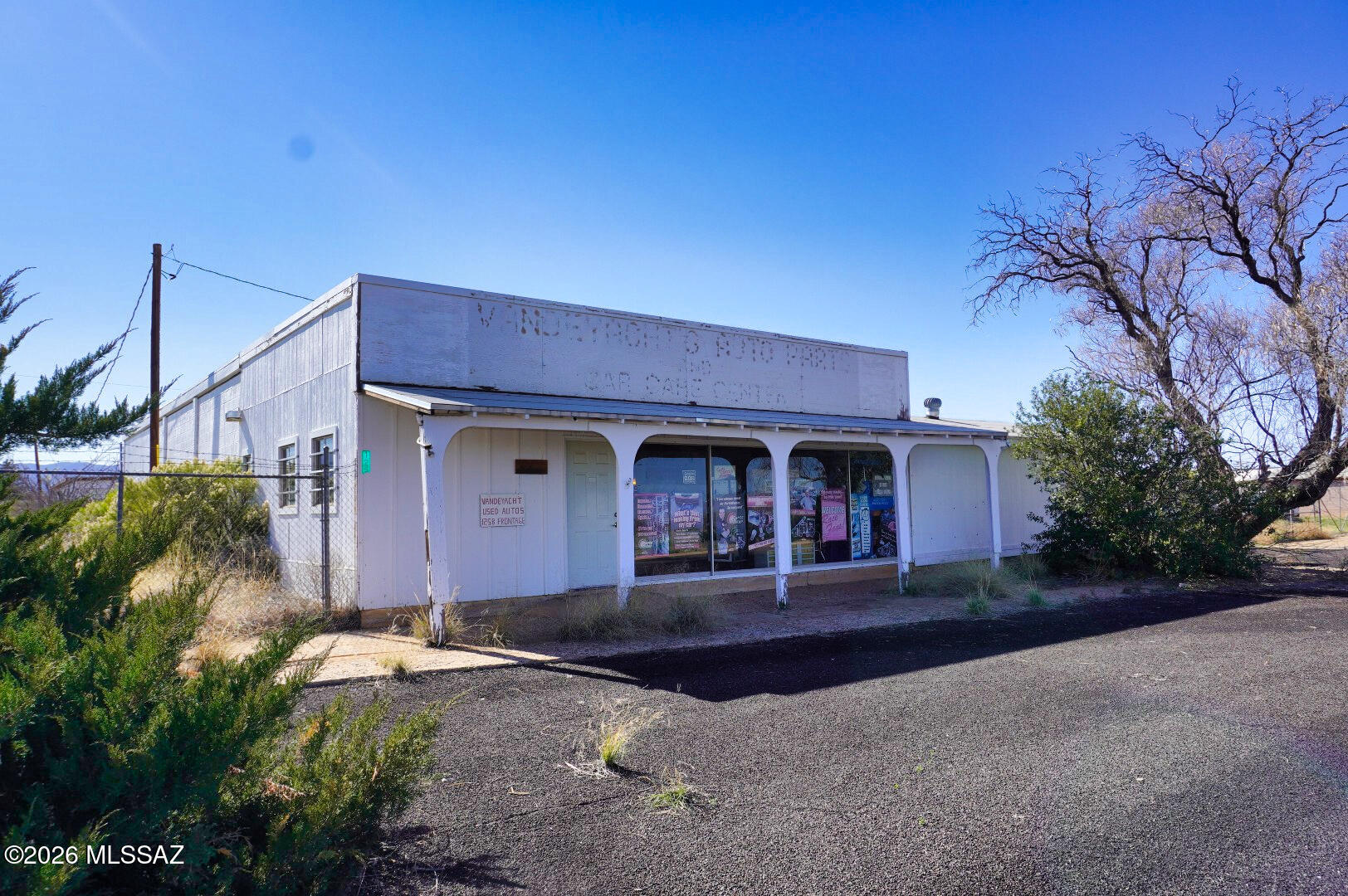 Excellent commercial opportunity with outstanding visibility along the frontage road of Highway 191 in Pearce, Arizona. This unique property offers both business and residential use, making it ideal for an owner-operator looking to live and work from the same location. The property features an automotive shop with a retail storefront in the front and four large service bays, The shop is fenced and gated and includes a large auto lift and an older forklift, both of which convey with the property. Situated behind the shop is a renovated two-bedroom residence, offering comfortable on-site living. The home features a cozy wood-burning fireplace and a shaded concrete slab front porch and was nicely renovated in 2016 and has not been occupied since.  House is 1288 SQ ST shop/Garage is 3172 Sq Ft The property consists of seven lots zoned GB.(General Business), providing flexibility for a variety of commercial uses. With steady residential and commercial traffic passing by daily, the location offers excellent exposure for a business. Roof on the shop and the home were repaired/recoated this year, 2026. Property is being sold as-is, where-is, with most items currently on site conveying with the sale, excluding a few personal belongings. This is a rare opportunity to own a highly visible commercial property right on Highway 191, with residential living in the back. Seller will owner carry with 50% down for up to 10 Yrs at 5% interest
