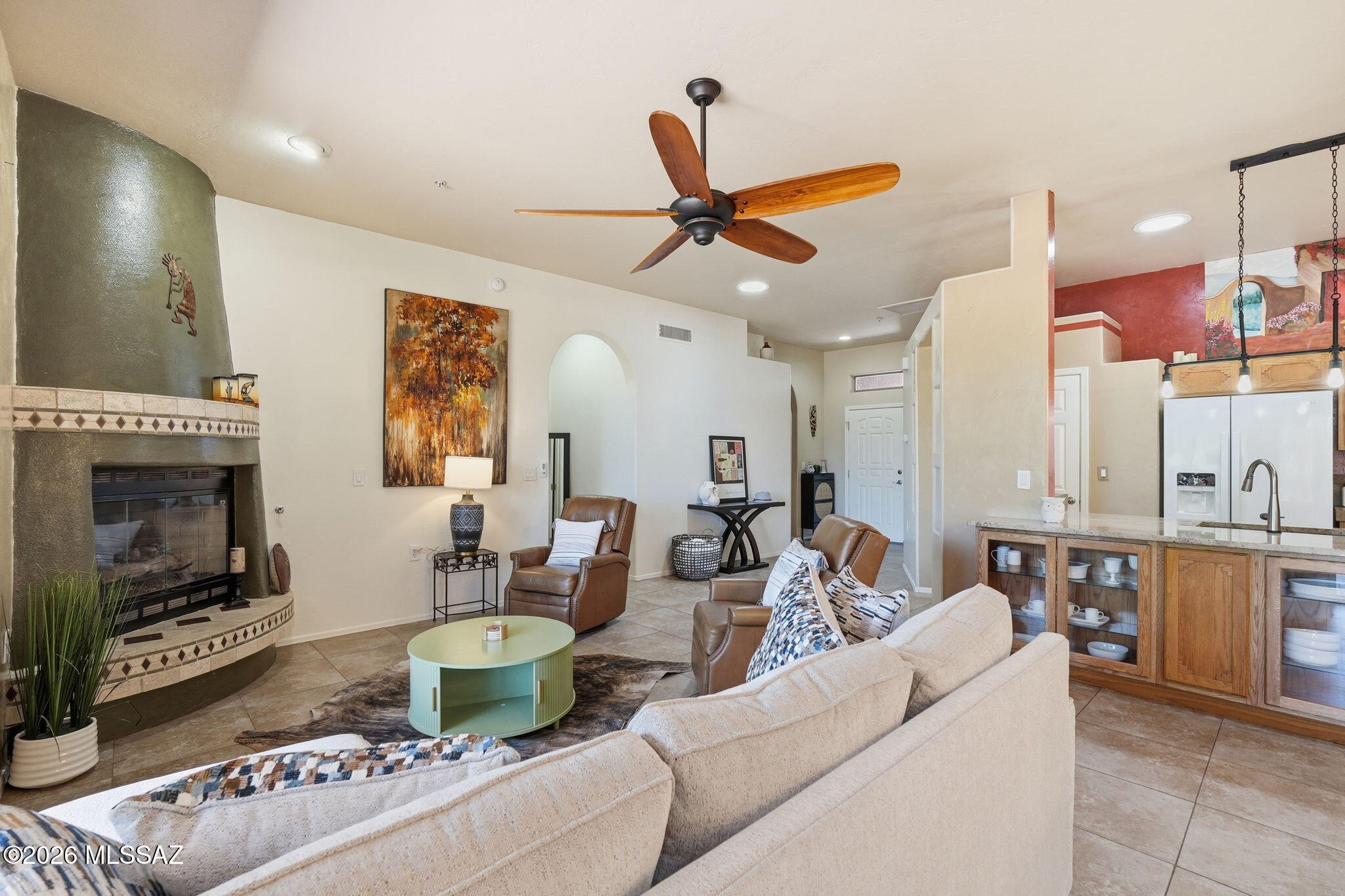 Perched along the 7th fairway of Torres Blancas Golf Course with breathtaking Santa Rita Mountain views, this beautifully updated Dorn townhouse is the one that stops buyers in their tracks. Thoughtfully maintained with major upgrades already completed, the home features an HVAC system replaced in 2015, a roof membrane replacement completed in 2019, and electronic patio screens that create the perfect blend of privacy and openness in the backyard living space. The home also includes a whole-home water softener system, providing softer water that is gentler on your skin and hair while also helping extend the life of appliances, plumbing fixtures, and water-using systems throughout the home. From the moment you walk through the door, you'll feel the light, openness, and pride of ownership throughout.

Offering 2 bedrooms, a den, 2 bathrooms, and a 2-car garage, this property perfectly blends comfort, warmth, and Arizona lifestyle living. The spacious great room is anchored by a stunning beehive gas fireplace, creating the perfect setting for cozy desert evenings, while four skylights flood the home with natural light and showcase the updated tile flooring and designer color palette.

The inviting kitchen features matching appliances, tile countertops, a breakfast bar, and a convenient separate laundry room just off the kitchen.

The spacious primary suite opens directly to the backyard patio, creating your own private retreat where you can enjoy peaceful golf course views and spectacular mountain sunsets year-round. The backyard is designed for both relaxation and entertaining, featuring a tranquil water fountain and refreshed outdoor finishes.

Homes with views, updates, and character like this rarely become available--especially in such an exceptional golf course location.
