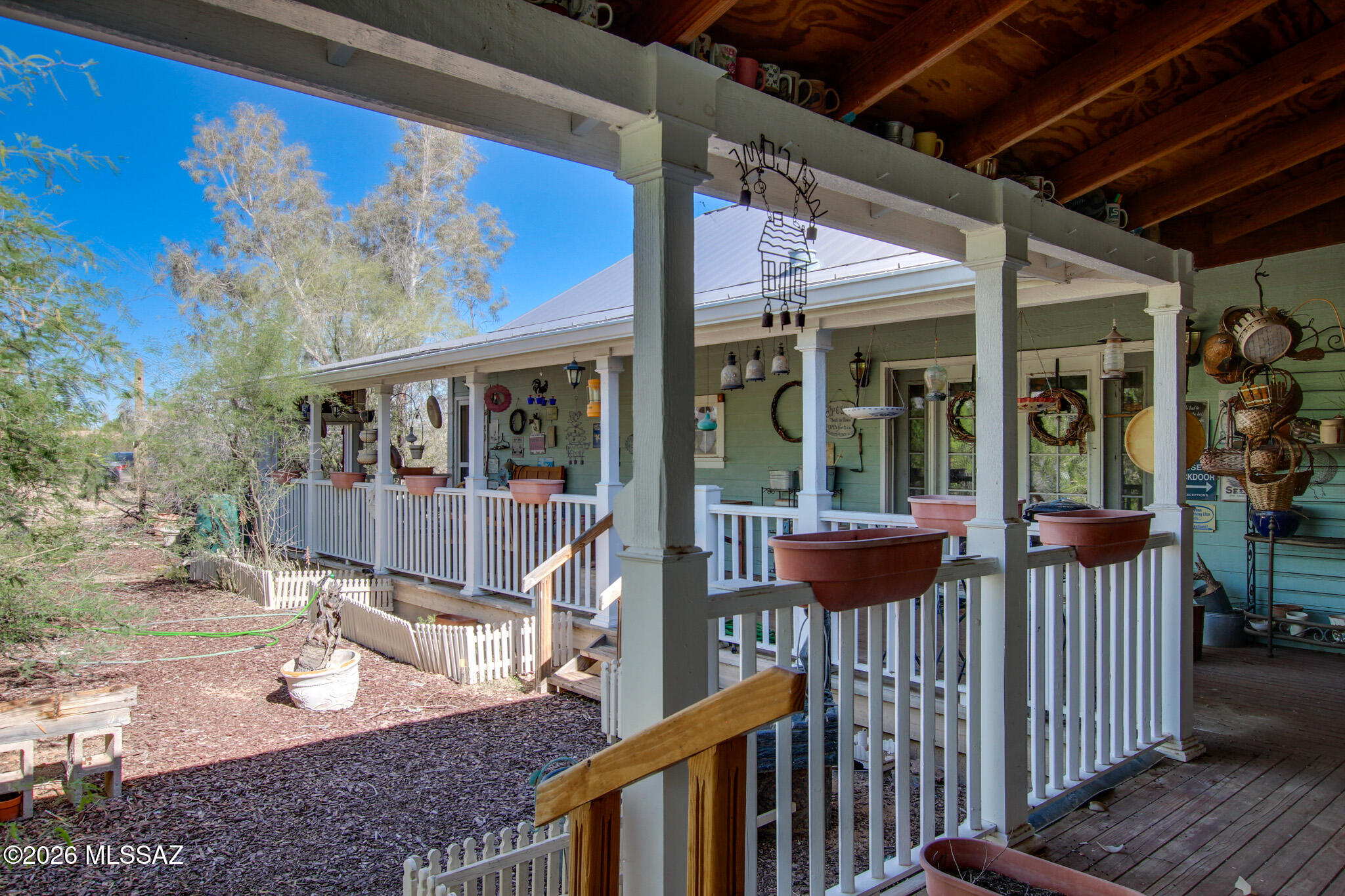5,300+ sq. ft. custom estate captures Mid-West charm, situated on 6.5 fully fenced acres. This property holds two separate kitchens, tow dining rooms, two fireplaces, and ample living space. Offering a versatile layout that could easily be converted into four bedrooms or serve as a comfortable multi-family residence. New AC units and a fenced pasture area plus corral/dedicated horse facilities. Includes a detached four-car garage with an integrated storage/workshop! Complete with a large L-shaped covered deck and metal roofing.