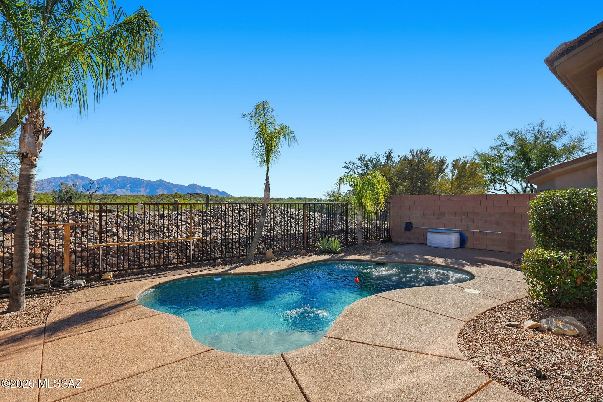 Stunning Catalina Mountain Views in the Bluffs at Dove Mountain. This split bedroom plan home backs to open preserve for privacy. Spacious 2112 SqFt 2-bedroom w/den, 3 full baths & 2 car garage home has a dual primary bedroom plan. Versatile den perfect for office, library, guest room, media lounge, hobby space or fitness area. Each primary w/ en suite bathrooms & closets. The kitchen features granite counters, black appliances, plenty of cabinetry, breakfast nook & breakfast bar. The spacious main primary bedroom features a slider to the back patio, dual vanities & walk-in closet. Updates: plantation shutters, 2022 HVAC, 2025 water heater/carpet/Pebble Tec pool. Backyard oasis with panoramic view, privacy, pool, space for spa, kiva fireplace, covered patio w/ fan & roll down shade.