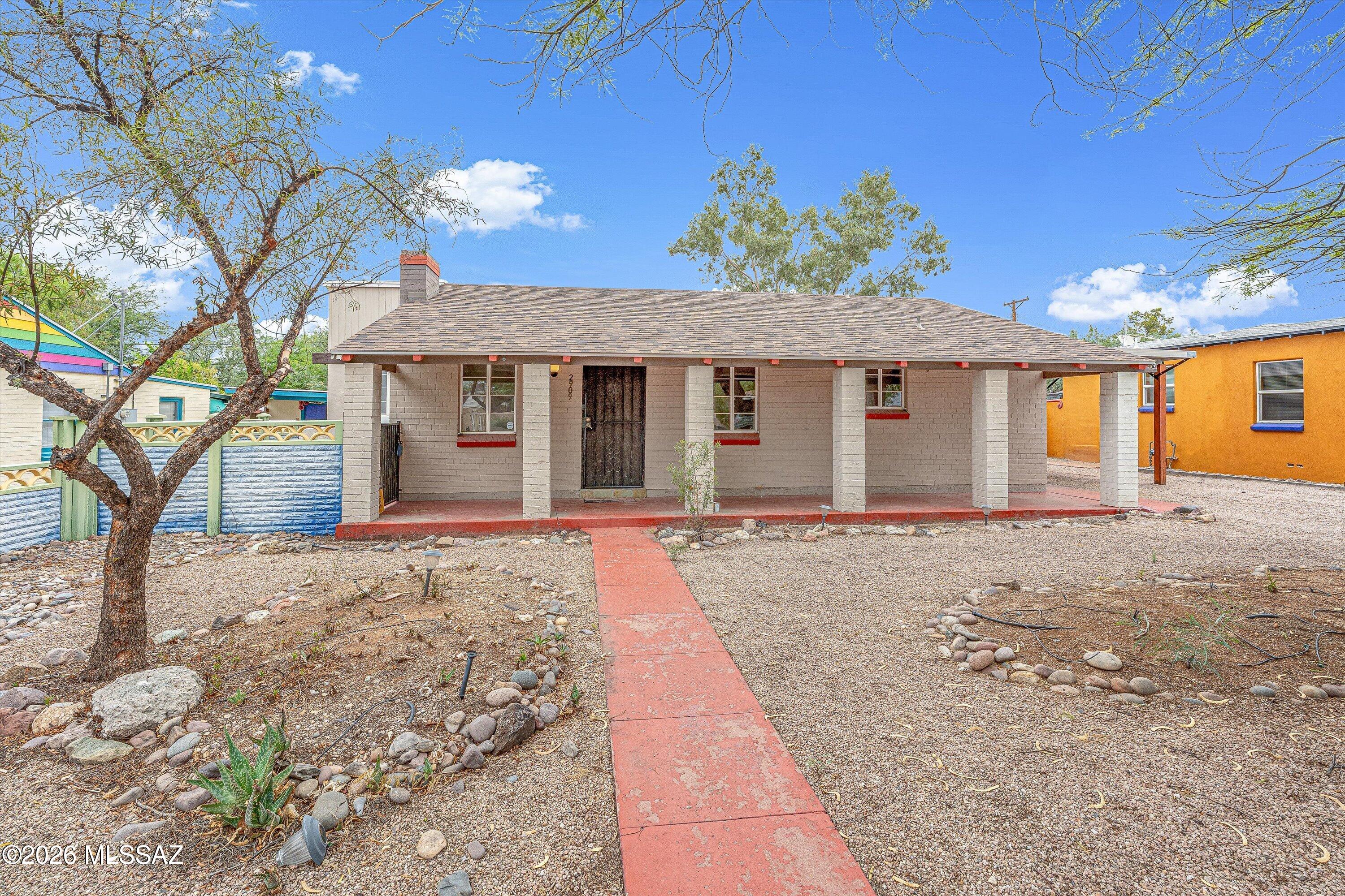 Charming 1940s Blenman Elm bungalow with historic property tax benefits. Thoughtfully updated while preserving its original character, this home offers the perfect blend of vintage charm and modern convenience. The spacious primary suite features a large walk-in closet w/ laundry, while the versatile bonus room is ideal for a home office. Major updates include new plumbing (2019), HVAC (2022), roof (2023), corrugated metal fencing (2024), and a tankless water heater. Relax in the private backyard beneath mature shade trees, complete with a covered ramada, paver patio, and peekaboo mountain views. The detached guest space with its own bathroom offers endless possibilities as a guest suite, studio, or office. A 20-foot rear gate provides easy access for larger vehicles. All of this in a prime central location just minutes from the University of Arizona, Banner University Medical Center, shopping, and dining.