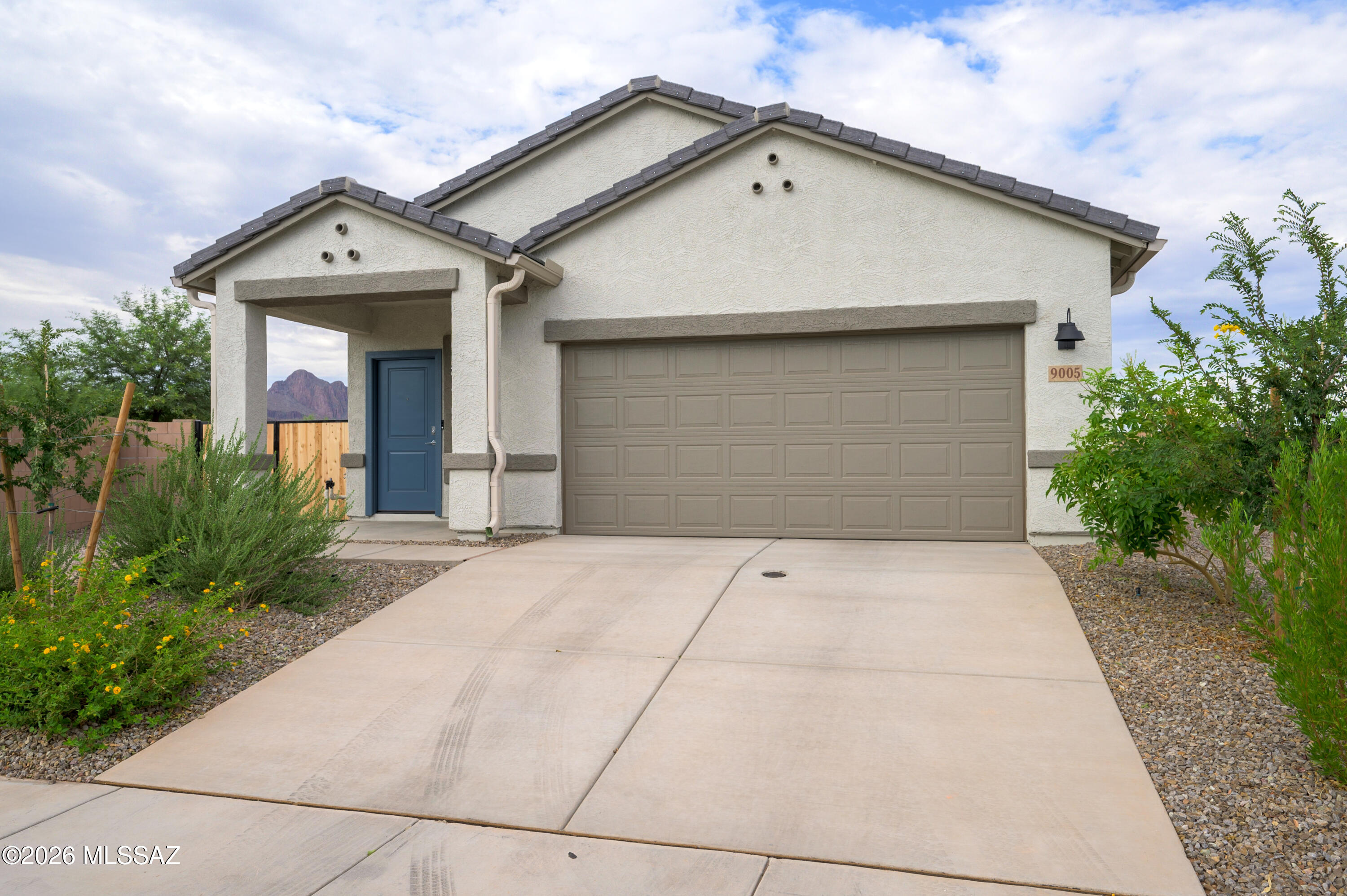 Ask about the assumable FHA loan with a 3.99% fixed interest rate to qualified buyers! Welcome home to this beautifully upgraded 2025 DR Horton home in the highly sought after Saguaro Bloom community. Situated on an oversized 12,090 square foot premium lot with mountain views, no rear neighbors, and extra privacy, this home offers an incredible outdoor setting. The thoughtfully designed 1,558 square foot floor plan includes 3 bedrooms and 2 bathrooms and is packed with custom finishes and upgrades. Upgrades in the home include a cozy electric fireplace, water softener, whole house water filtration system, additional recessed lighting throughout, an accent wall in one of the secondary bedrooms, and a double gate providing easy access to the backyard. The open concept floor plan features a stunning kitchen that includes an island with breakfast bar seating, stainless steel appliances, a gas range, and a pantry. The primary bedroom is a spacious retreat that includes dual vanities, a walk-in shower, and a generous walk-in closet. The oversized backyard offers endless possibilities with plenty of room to add a pool, create the outdoor living space of your dreams, or simply enjoy the beautiful mountain views. Residents of Saguaro Bloom enjoy resort style amenities including community pools, a splash pad, fitness center, parks, and walking trails, all just minutes from shopping, dining, and the Marana Aquatic and Recreation Center. This move in ready home combines the benefits of new construction with valuable upgrades already completed for you.