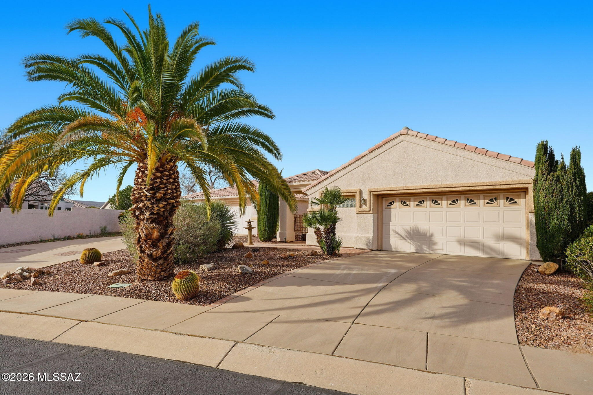 Nestled within the charming, gated community of Sunrise Pointe Vistas, this beautifully maintained home offers an exceptional blend of comfort and style with a fantastic location. A mature palm tree sets a welcoming tone as you arrive, with a paver walkway guiding you to the covered front porch. Step inside to discover soaring 10-foot ceilings accented by elegant tray details that create a refined, polished atmosphere from the moment you enter. The expansive main living area is wonderfully versatile--ideal for a traditional living room, a combined living and dining space, or even a creative hobby area. Double doors open to a private home office complete with a Murphy bed, offering flexibility for overnight guests or a comfortable work-from-home setup. Just off the kitchen, an additional living space invites you to relax and gather around its cozy gas-burning fireplace--the perfect focal point for everyday living or entertaining. The large kitchen is both functional and stylish, featuring granite countertops, a center island with breakfast bar seating, and abundant cabinetry for all your storage needs. Efficient Andersen windows throughout the home flood the interior with natural light, enhancing the open, airy feel created by the tall ceilings and generous room sizes. The primary bedroom continues the sophisticated tray ceiling design and serves as a true retreat, complete with a luxurious en suite bath showcasing a custom tile shower and double-bowl vanity. Out back, unwind in your private oasis where thoughtfully designed, low-maintenance native landscaping creates a serene setting. A built-in tile and stucco bar area is already in place and ready for your vision, with a gas hookup available should you wish to add a barbecue. The garage is equally impressive, offering attached cabinetry along with extra space ideal for a small workshop or golf cart storage. This inviting home combines elegance, flexibility, and ease of living--an ideal opportunity to enjoy all that Green Valley has to offer. Come make it your own.