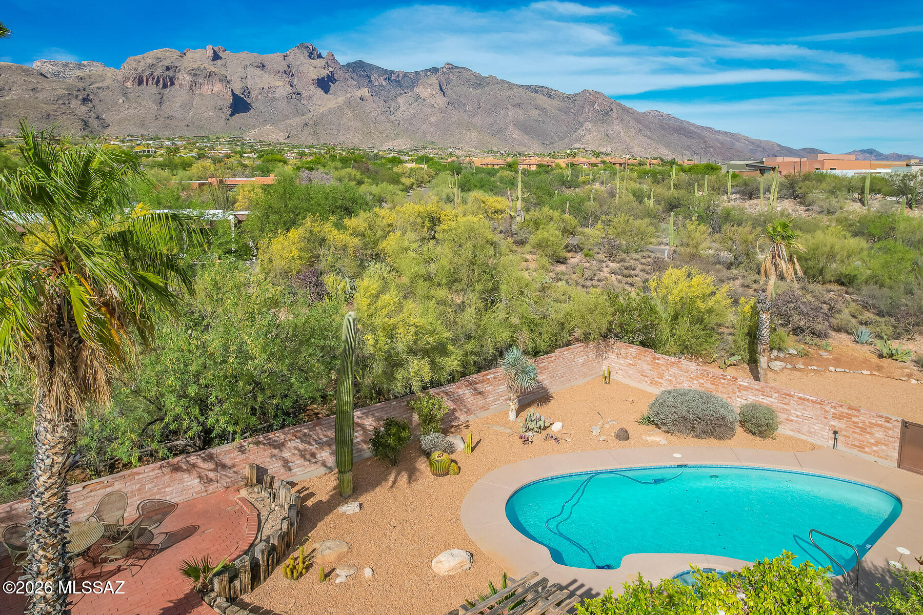 Prime Catalina Foothills # 9 neighborhood within walking distance to dining and shopping at La Encantada. 
This 4BD/3 BA home features solid burnt adobe construction, exposed cedar beamed ceilings in the family room with fireplace and wood interior doors throughout. Functional floor plan with separate living and family rooms, formal dining, breakfast area, and kitchen with walk-in pantry. 
North/south orientation with Beautiful backyard pool and Stunning Santa Catalina Mountain views. 3-car garage plus large storage area. Premium 1 ac lot!