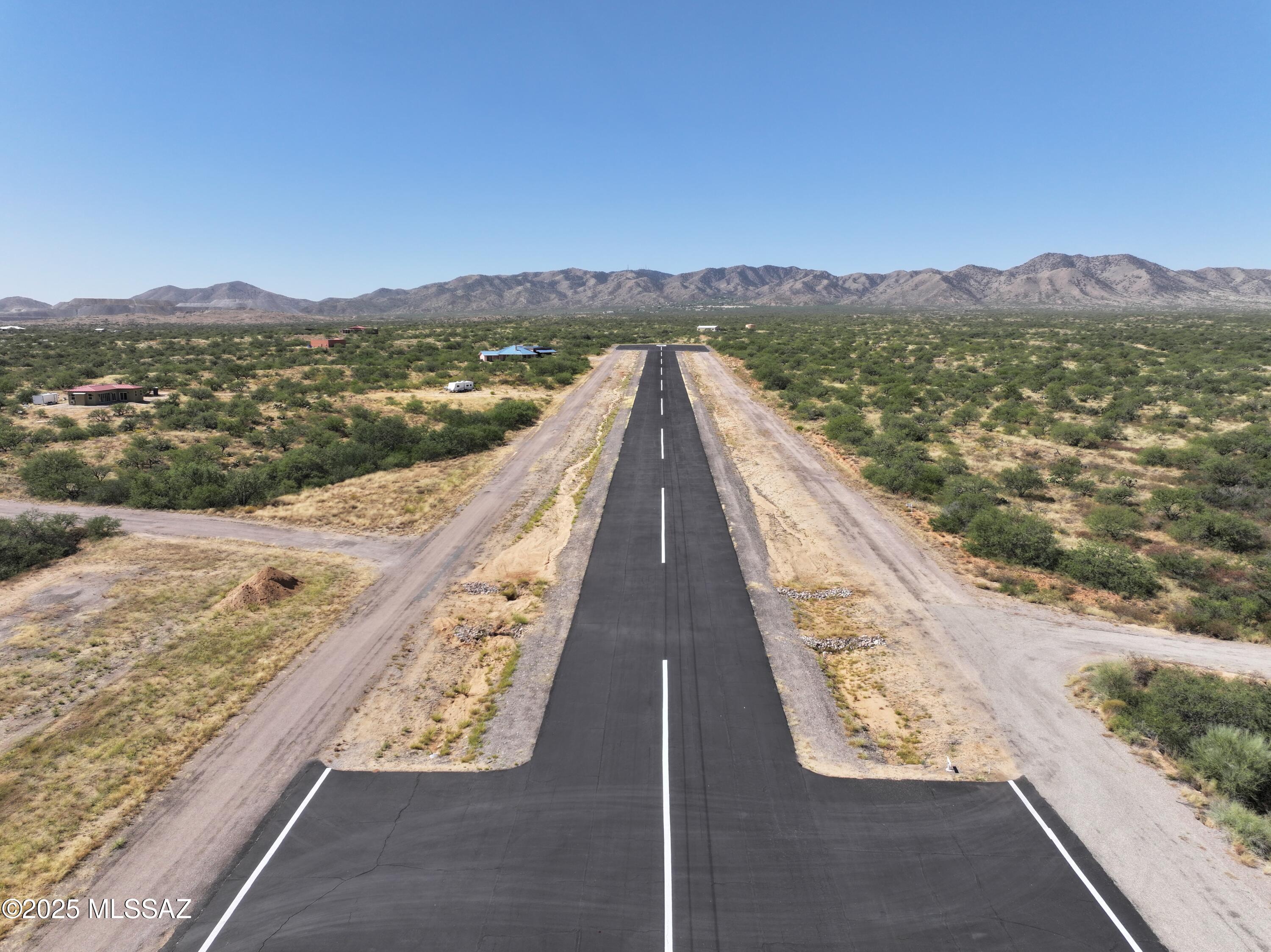 This 7.72-acre lot in Ruby Star Airpark offers stunning mountain views in every direction, including a clear view of Tucson and the windsock from the homesite. The property is already cleared for a homesite and taxiway, with a conventional septic system in place. Located directly on the airpark runway, it's ideal for aviation and equestrian enthusiasts. Enjoy breathtaking sunsets, sunrises, and access to thousands of acres of State Land. Has septic-graded land and runway access!!!