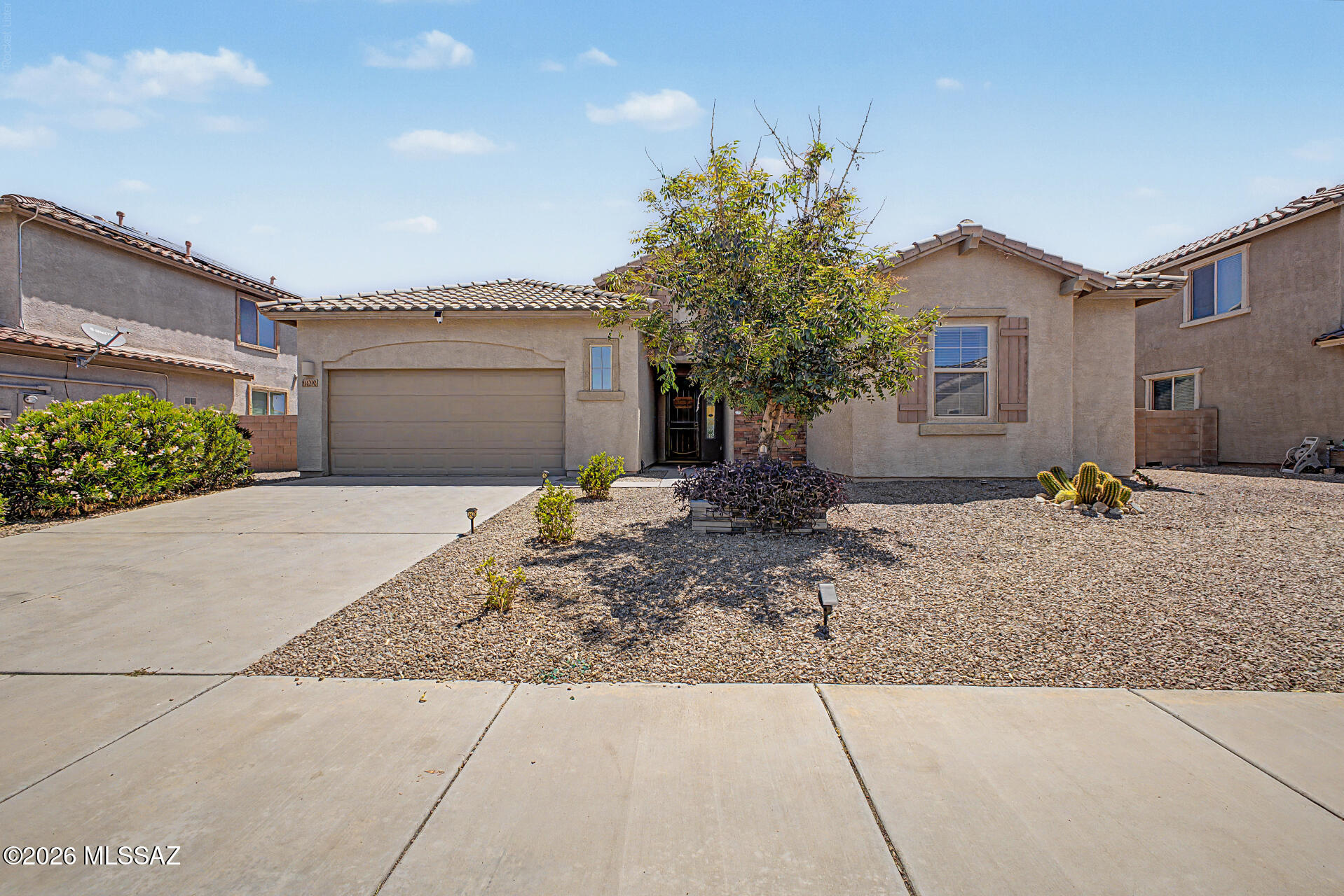 Welcome to this beautifully maintained home in desirable Marana! Featuring an open floor plan with vaulted ceilings, this home offers comfortable living and effortless entertaining. The spacious kitchen includes a double oven and flows seamlessly into the main living areas. Retreat to the generous primary suite with two large walk-in closets and plenty of storage. Enjoy added privacy with no neighbors behind the property. Conveniently located near community parks, basketball courts, walking paths, a dog run, and easy freeway access for commuting. This home combines comfort, convenience, and a great location in one exceptional package.
