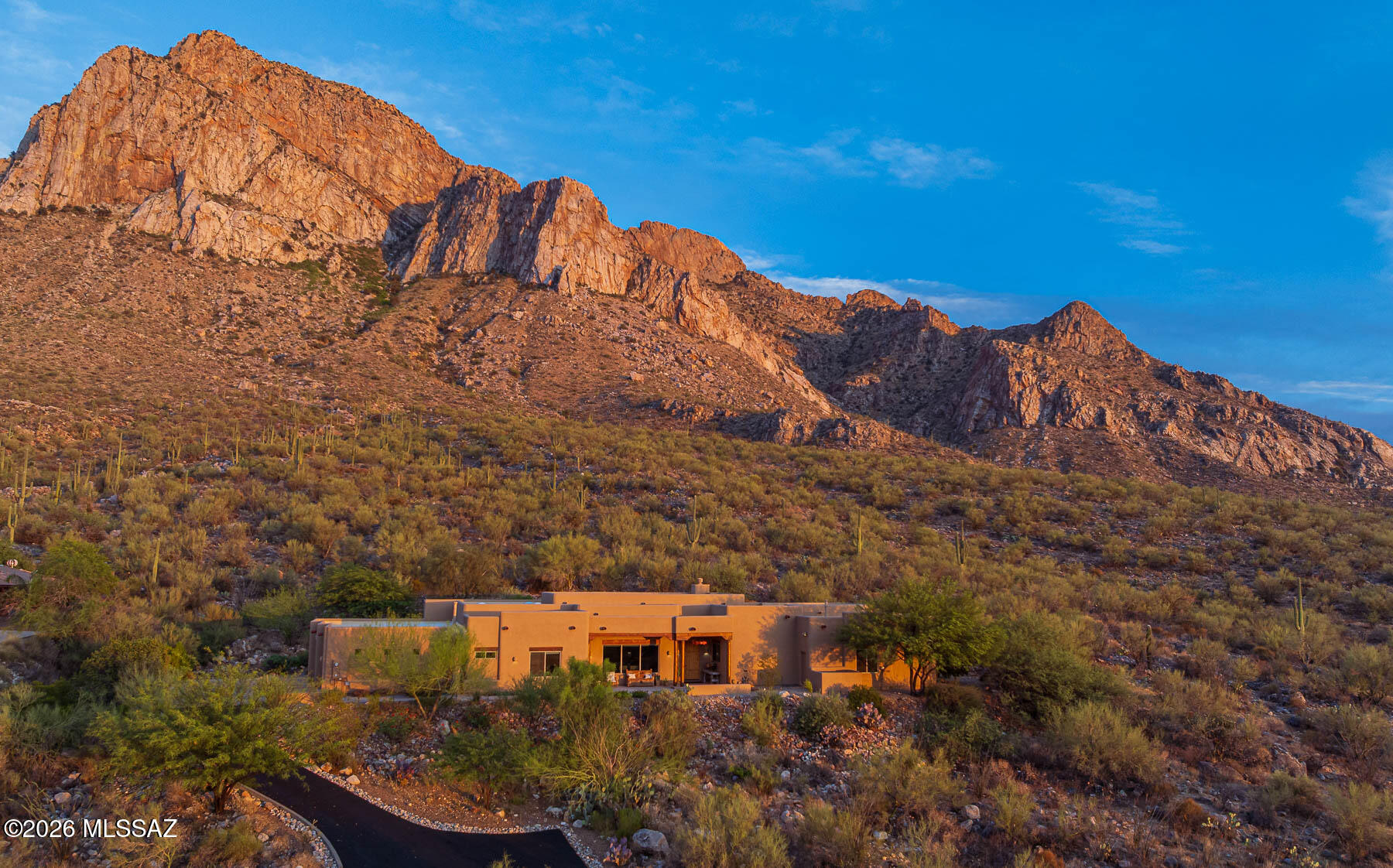 Stunning and dramatic is what you drive up to for this beautiful home perched on 8 acres backing to the national forest and possibly the best view of Pusch Ridge out there. The front of the home has sweeping views of the tortolita mountains and town lights. Basically every room and patio has a view. The home is custom built by McCreay Homes and lovingly maintained by the original owner. It features neutral tones with soaring wood ceilings and a spacious open great room/kitchen/dining room. Flexible rooms allow for 4 Bedrooms, offices or media room. Primary suite also includes an office.  The property has numerous patios, fountains and an abundance of open space and privacy. Located in gated La Reserve its close to shopping, hospitals and many outdoor trails. Truly wanting the Tucson free with nature everywhere-this is your spot