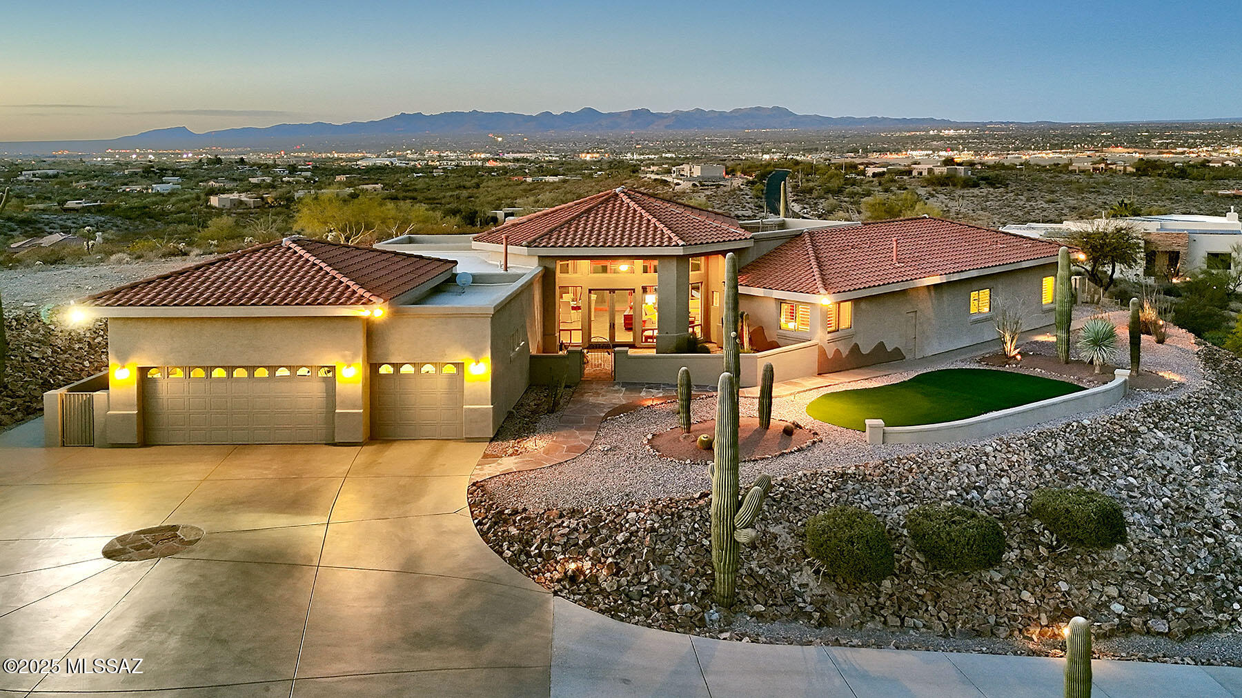 High up on a hill top in a gated community overlooking a sea of lights & softening pink of the Catalina Mountains at sunset, All this & a stunning contemporary home. The great room has walls of windows overlooking  an extensive covered patio and an infinity pool & spa. Don't miss the roof deck with forever views in all directions. A beautiful home for entertaining  & for enjoying the joy of desert living in a home thoughtfully designed around indoor-outdoor spaces. The great room is large enough for entertaining but cozy enough for a  comfortable quiet life. The spacious kitchen w/ center island, gas stove, stainless steel appliances & an abundance of cabinet  and counter space will please those who love to cook. An outdoor grill on the outdoor north patio means it's always comfortable to take cooking outside. Step into the private & quiet  primary ensuite that features a large bedroom w/ doors to the outside & pool, a huge walk-in closet and a spa-like bathroom w/ separate vanity areas, a jetted tub & a large dual shower. 
Three bedrooms, three & a half baths - one split makes perfect guest suite or home office. The very, very large laundry room & the 3 car garage provide space for many hobbies or exercise equipment. This exceptional home filled with natural light is spacious, immaculate & ready to move into.