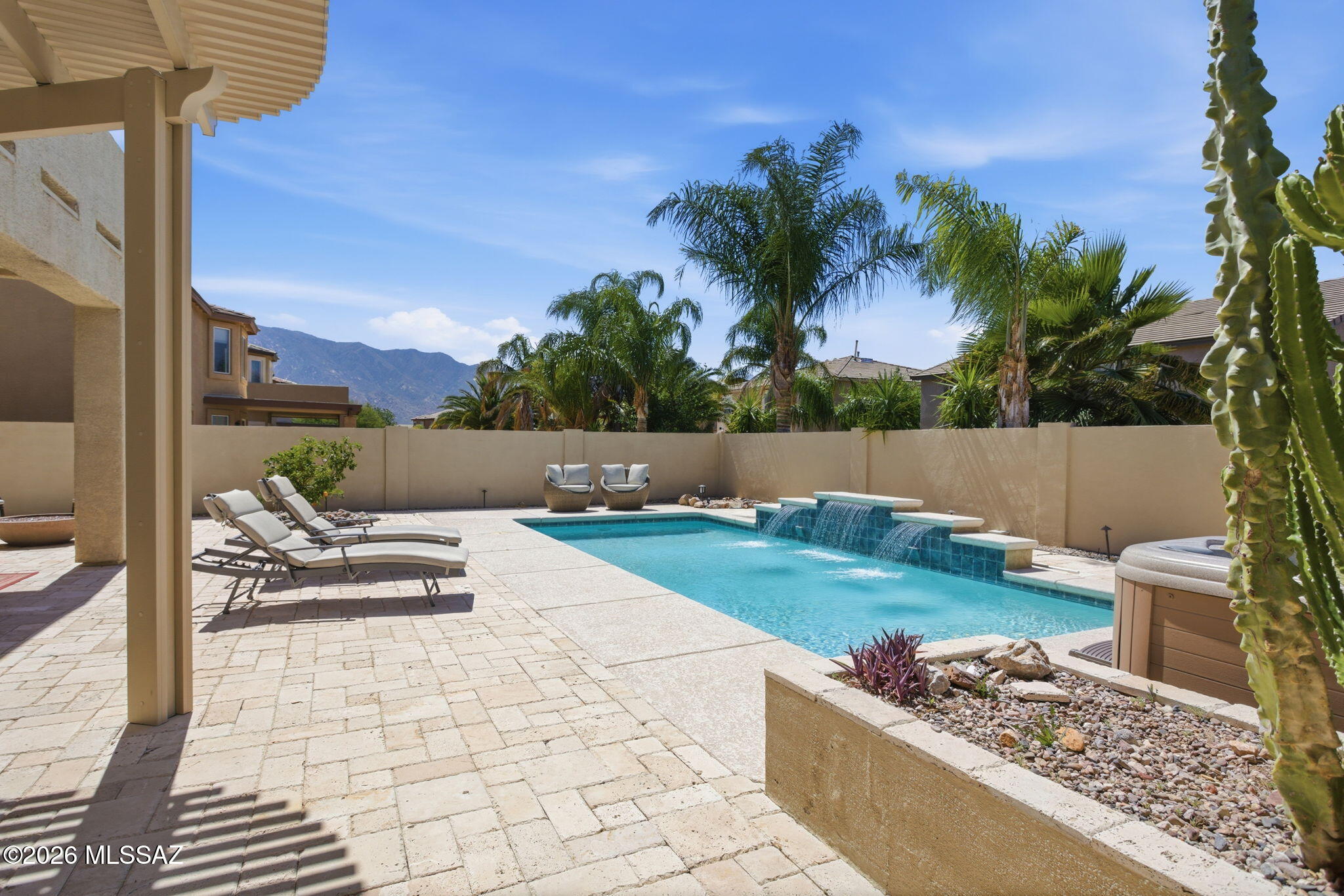 Nestled in Black Horse Ranch, this turnkey, two-story home offers 2,245 square feet of luxurious living. Featuring three spacious bedrooms and 2.5 baths, the home combines comfort with elegance. Owned solar panels ensure energy efficiency, while the resort-style backyard is an entertainer's dream--complete with a saltwater pool, waterfall, hot tub, covered pergola, outdoor barbecue, and misting system hookups. Surrounded by fruit trees and travertine pavers, this private oasis invites relaxation. Inside, a light-filled open layout connects the formal living and dining areas to a cozy family room off the kitchen. The chef's kitchen boasts stainless steel appliances, a gas range, double ovens--perfect for holiday gatherings--and ample granite countertops with upgraded cabinets. Upstairs, a versatile loft with a balcony offers breathtaking mountain views. The expansive primary suite is a true retreat, featuring a spa-like en-suite and a lavish walk-in closet. Plus, for added convenience, the home can be sold fully furnished--just move in and enjoy!