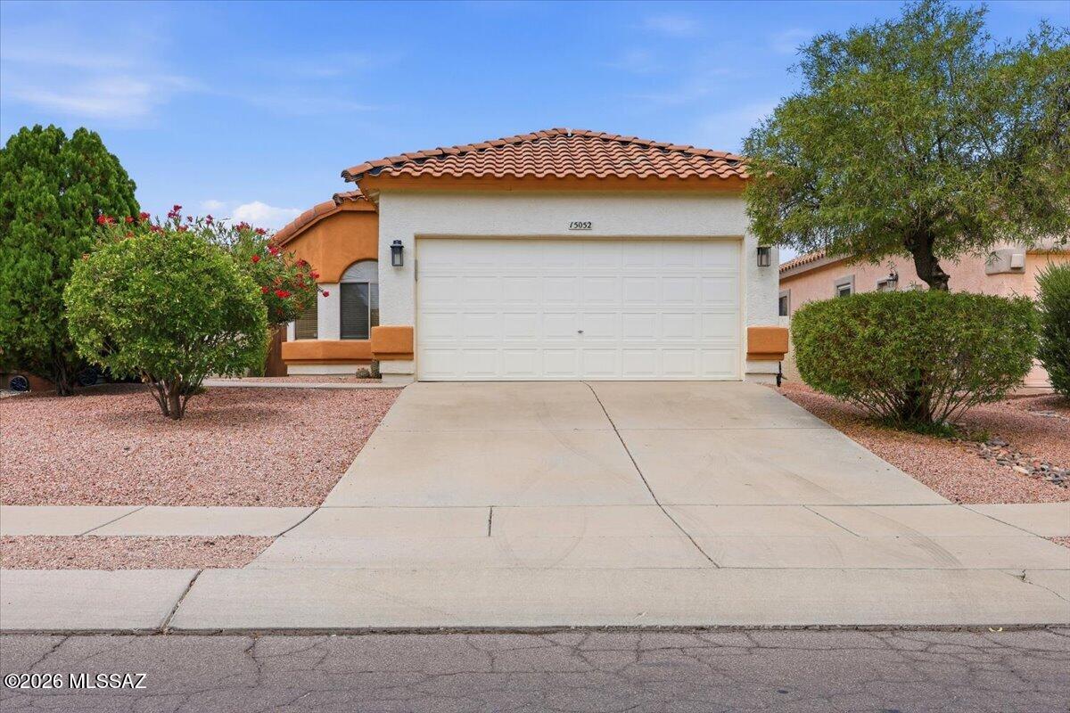 Nestled in the heart of Rancho Sahuarita, this charming three-bedroom, two-bath home offers a smart, open-concept layout that's perfect for both relaxing and entertaining. Built in 2002, it features high ceilings, custom tile flooring, and a spacious kitchen with tons of counter space and cabinetry. The low-maintenance backyard is fully fenced with a covered patio making it readily available to conform to an ideal space for adults, children, and pets. Residents enjoy access to multiple community pools, a fitness center, a splash park, trails, a stocked fishing lake, and so much more. It's comfortable desert living at its finest!
