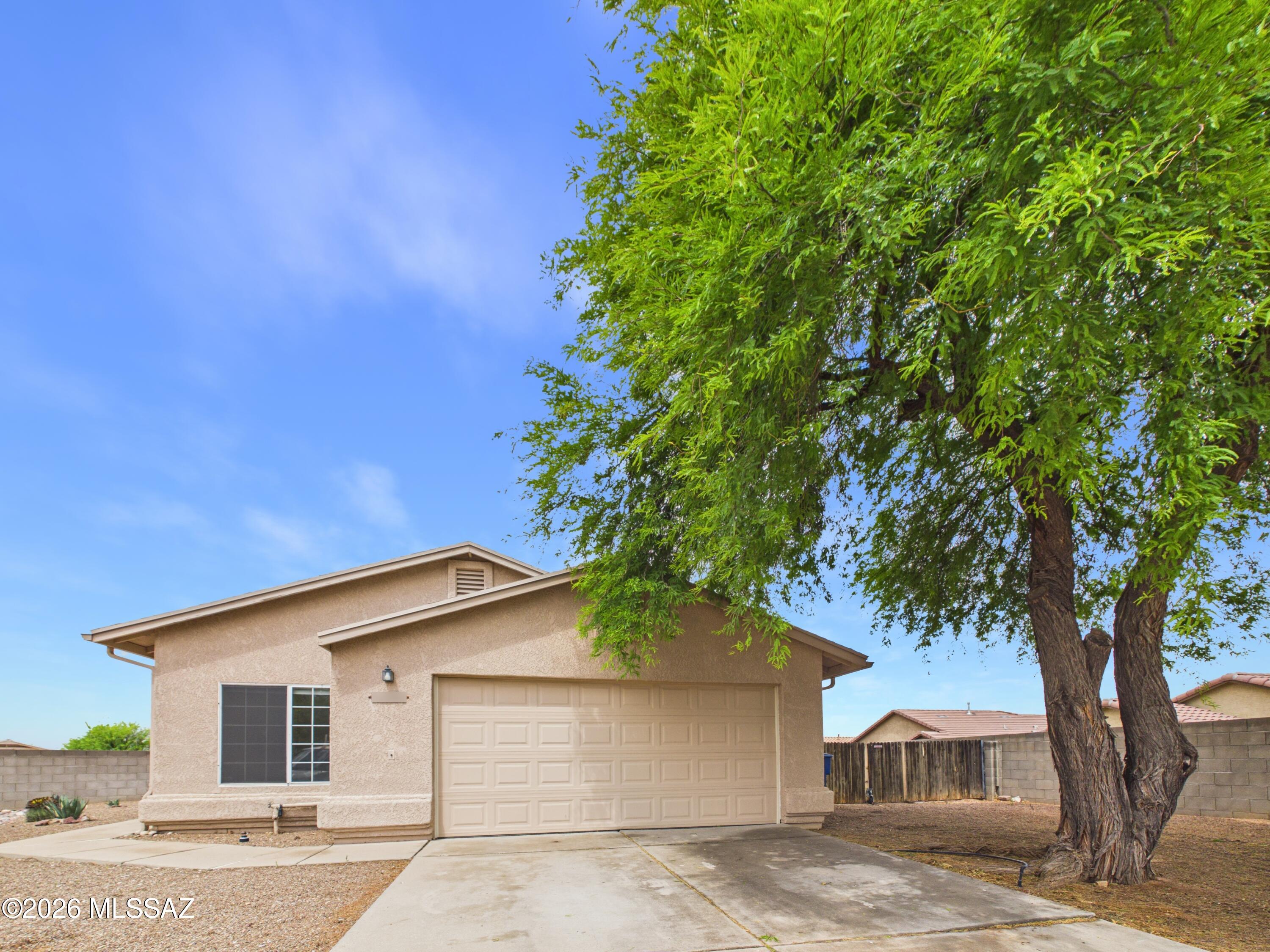 Move in ready single-story home offering comfortable living in a convenient east Tucson location. This property features a functional layout with spacious living areas, abundant natural light, and a seamless flow between the living room, dining area, and kitchen. The primary suite provides a private retreat with an en-suite bath, while additional bedrooms offer flexibility for guests, office space, or hobbies. Enjoy a huge yard with room to relax or entertain large parties, with room for about 8 additional cars to park in this long extended  driveway.