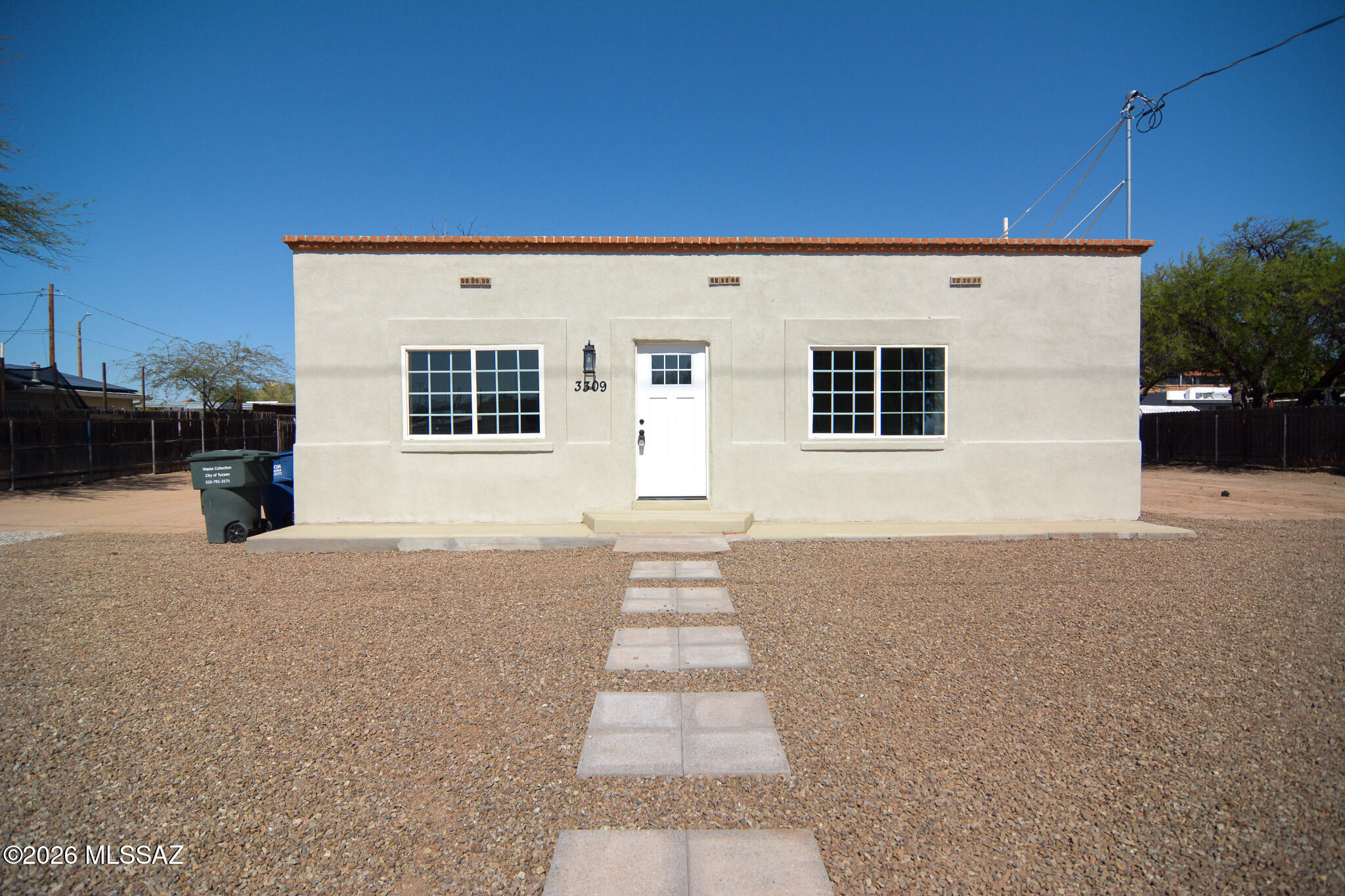 Beautifully remodeled Southwestern style home. Located in a convenient South Tucson location. Charming block construction. Rich wood look LVP flooring. Updated modern kitchen with stainless steel appliances. New custom interior and exterior paint. Updated bathrooms. Ceiling fans in each room. Large fenced yard. Mature tree. Upgraded door hardware and light fixtures. New dual pane windows, HVAC, water heater. No HOA. This home shows beautifully.