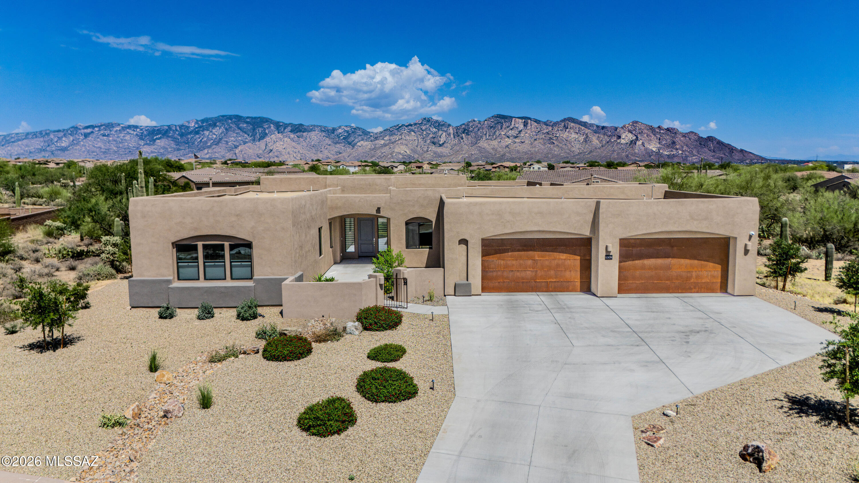 Experience luxury desert living in this stunning custom home built by Insight Homes. Nestled within the gated community of Tortolita Vistas , this exceptional semi-custom residence by Insight Homes offers luxury desert living with panoramic mountain views and refined craftsmanship throughout. Built in 2024 on a spacious 0.74-acre homesite, the home encompasses approximately 4,087 square feet with 4 bedrooms, 3.5 bathrooms, a private den, and an oversized 4-car garage with epoxy coated flooring and a 4-foot extension. Designed with a desirable split-bedroom floor plan, the home features soaring ceilings, expansive living spaces, and upgraded finishes that blend contemporary comfort with Southwestern elegance. The gourmet kitchen is equipped with custom cabinetry, premium appliances, oversized 13.5 foot island, granite surfaces, and abundant storage, flowing seamlessly into the great room highlighted by a stone cladded gas fireplace and walls of glass that capture the surrounding desert landscape. The spacious primary suite serves as a private retreat, while secondary bedrooms provide comfort and flexibility for family and guests. A dedicated den offers the perfect space for a home office, media room, or fitness area. Modern conveniences include a tankless water heater, low-emissivity windows, fire sprinkler system, and zoned heating and cooling. Outdoor living is equally impressive, featuring an extended covered patio ideal for entertaining or relaxing while enjoying unobstructed views of the majestic Catalina Mountains. The oversized homesite provides privacy, open skies, and the serenity that makes Tortolita Vista one of Southern Arizona's most sought-after luxury communities. Combining new construction quality, thoughtful design, mountain vistas, this residence delivers an exceptional opportunity to experience upscale desert living at its finest.