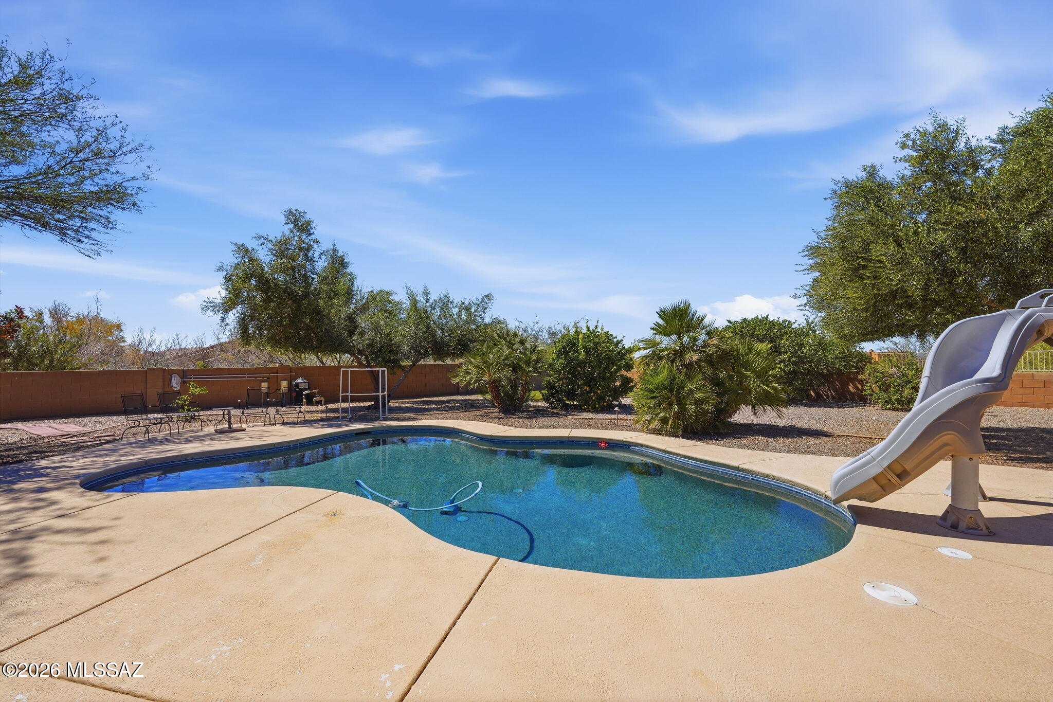 Opportunities like this don't come along often! This move-in ready 5-bedroom, 3-bath home in Rincon Trails sits on .51 acres with no rear neighbors, offering the space and privacy buyers have been searching for. The backyard is designed for Arizona living with a sparkling pool, barbecue and seating area for entertaining, plus an enclosed patio that extends your living space year-round. With generous indoor and outdoor living, this home is ready to enjoy from day one. Don't miss your chance to make it yours!