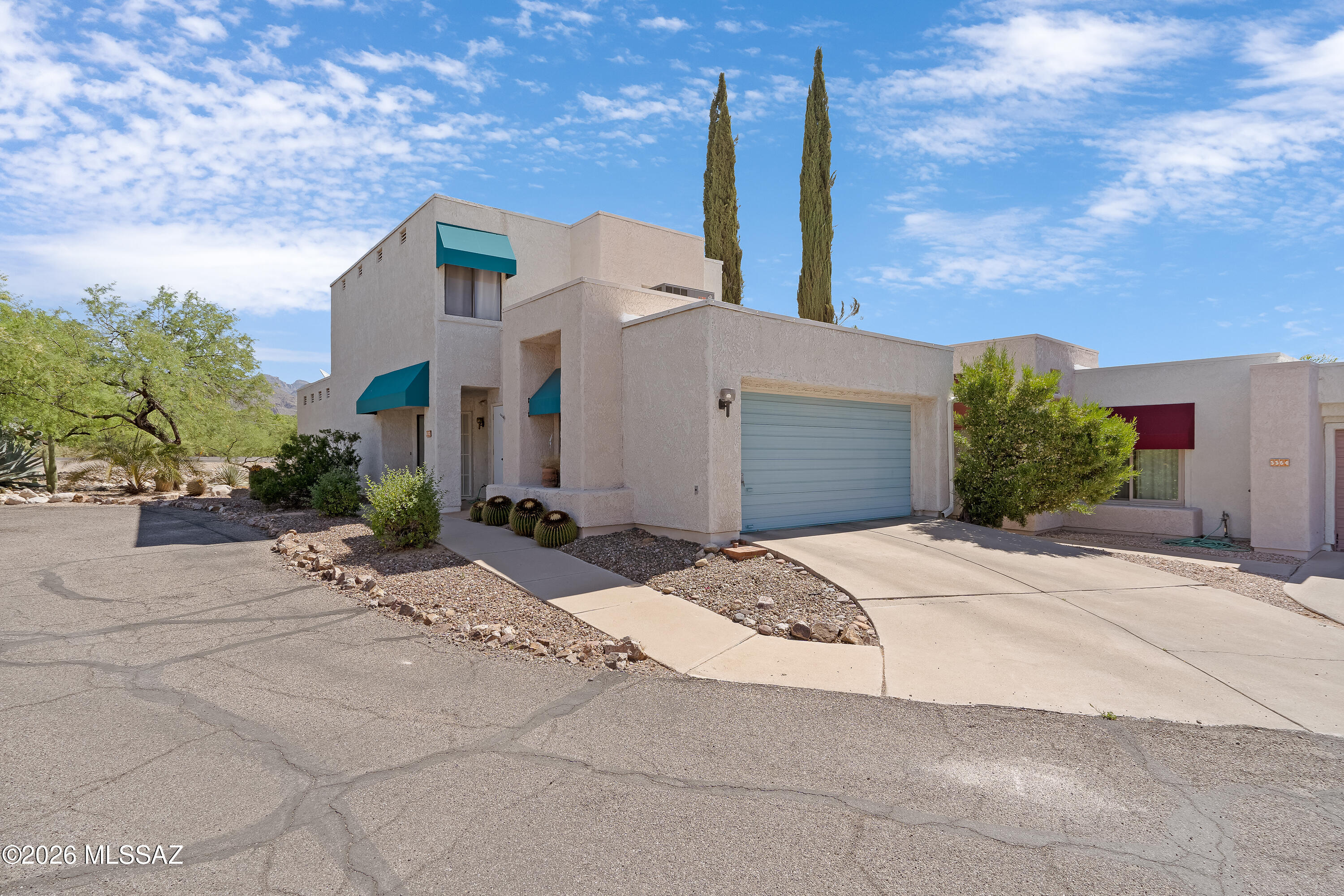 Inviting contemporary, two-story located on a cul-de-sac, this well-designed, functional home features a spacious primary suite with ensuite bath on the main floor, soaring ceilings in living room with fireplace, kitchen with granite countertops and stainless steel appliances, large powder bath. Upstairs, two additional bedrooms share a Jack-and-Jill full bath. Backyard with mature trees and mountain views, includes a private screen porch. Owners had polybutylene pipes replaced. Convenient community pool! All within the award-winning Catalina Foothills School District.
