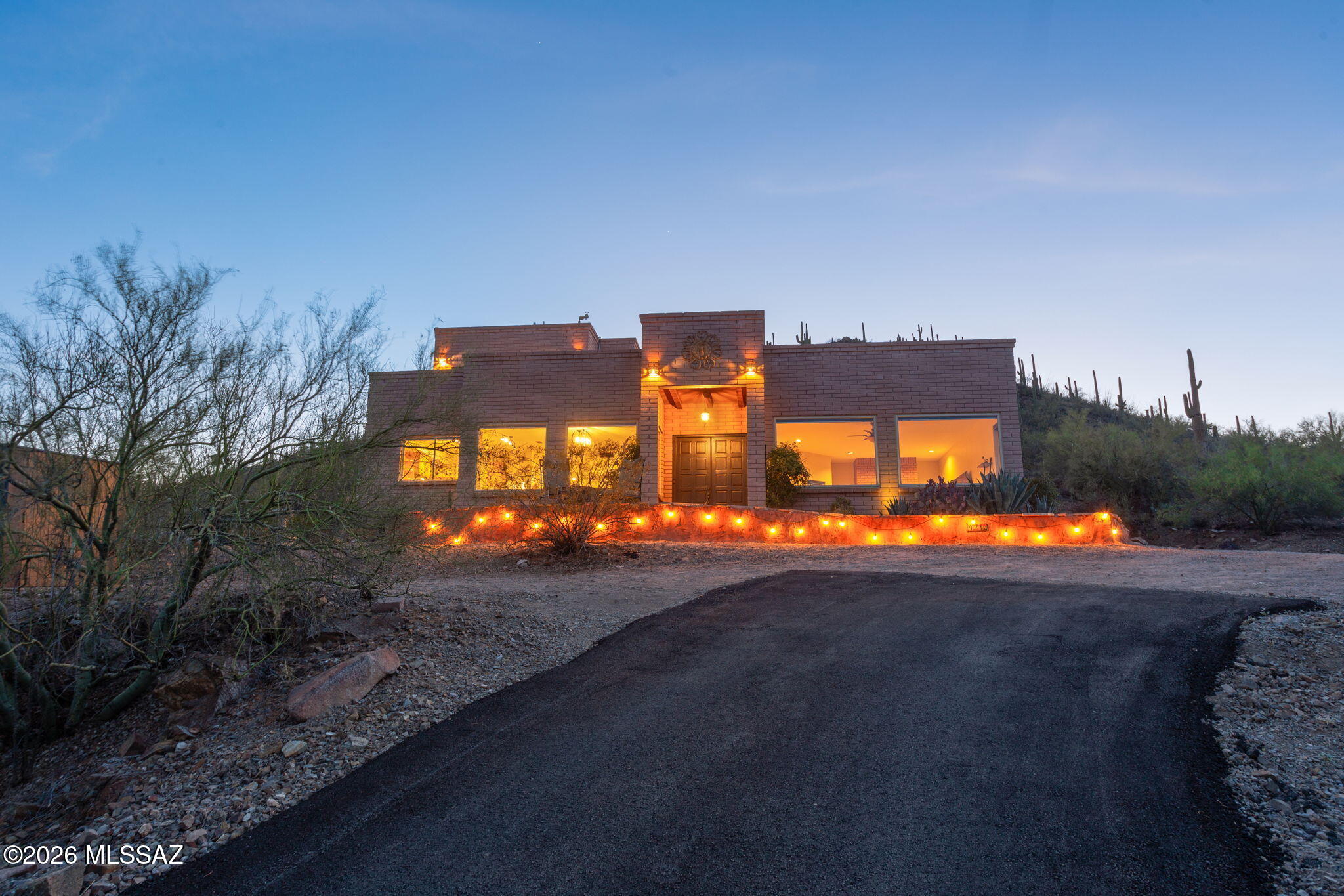 Experience elevated desert living at 4210 W Mossman Road - where space, privacy, and spectacular views create a truly special Tucson retreat. Set on 4.07 acres with no HOA, this home offers sweeping mountain vistas, vibrant Arizona sunrises and sunsets, incredible nighttime city lights, and a peaceful setting surrounded by the natural beauty of the Sonoran Desert. The spacious floor plan is designed for comfortable living and entertaining, with inviting interior spaces and abundant natural light. Recent improvements include a new built-up roof, two Trane multi-stage HVAC units, repaved driveway, fresh paint throughout, updated Coretec Originals downstairs flooring, and a full downstairs bathroom renovation - adding comfort, functionality, and long-term value. A fully owned 3.25kW solar system, newly installed Levolor solar shades, and slump-block construction help keep utility costs low throughout the year. The elevated homesite is a standout feature - providing stunning views all the way across the Tucson valley and an ideal backdrop for quiet mornings, outdoor gatherings, or relaxing evenings under the desert sky. With over four acres running up and over the adjacent hilltop, the property is like your own slice of Saguaro National Park with convenient proximity to shopping, dining, and outdoor recreation.
Offering valuable upgrades, exceptional privacy, and unforgettable views, 4210 W Mossman Road is a rare opportunity to own a beautiful desert property that captures the very best of Tucson living.