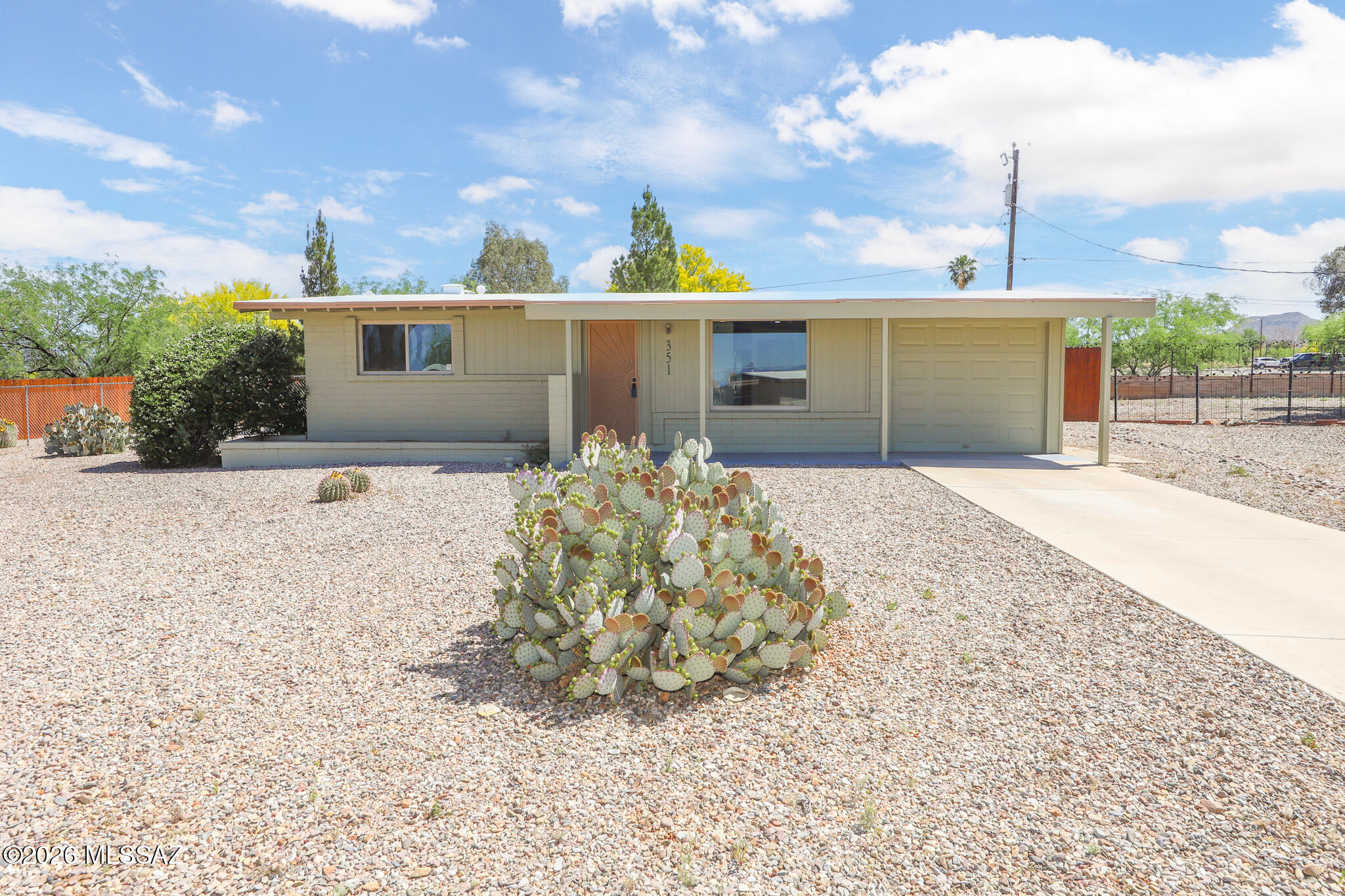 Located on an almost 1/4 acre Cul-de-sac lot, this fully remodeled, move-in ready home offers a bright, open split 3 bed/2 bath floor plan. Mature landscaping & beautiful curb appeal welcome you in, where you'll find a spacious great room filled w/ natural light from a large picture window, complemented by wood-plank tile flooring throughout most of the home. The updated kitchen features quartz countertops, newer cabinetry, decorative tile backsplash, farmhouse sink, black SS appliances, recessed lighting, & a versatile movable island. Both bathrooms have been thoughtfully upgraded, w/ a tiled guest bath surround & a stunning full tile shower in the primary suite. Step out to a large covered patio overlooking a spacious backyard w/ Santa Rita Mountain views & thriving garden area, perfect for enjoying Arizona evenings. Additional updates include dual pane windows throughout, a new water heater, and a new mini-split in the primary bedroom for added comfort.