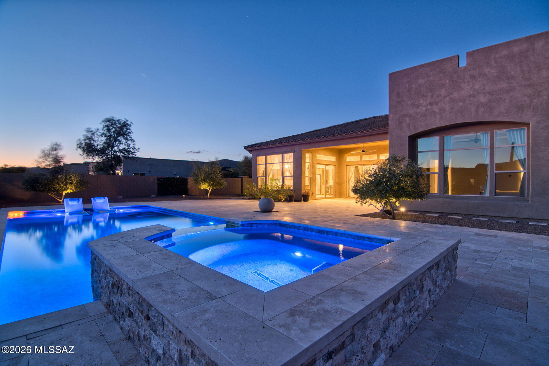 Discover one of the nicest homes available in Los Saguaros, showcasing Toll Brothers' finest craftsmanship. Perfectly positioned to take advantage of the stellar Southern Arizona Sunsets. This residence captures sweeping views of pristine natural desert, majestic mountains, and unforgettable AZ sunsets. The resort-style backyard is an entertainer's dream--beautifully designed with a  heated pool expansive travertine paver patio that invite year-round outdoor living. The great room is anchored by a stunning stone fireplace and media wall. travertine stone entry to wonderful courtyard. The home features an RO system, water softener and hi tech lighting.  Enter the dramatic courtyard complete with travertine pavers and stone walls. This home is a winning combination of elegance and comfort.