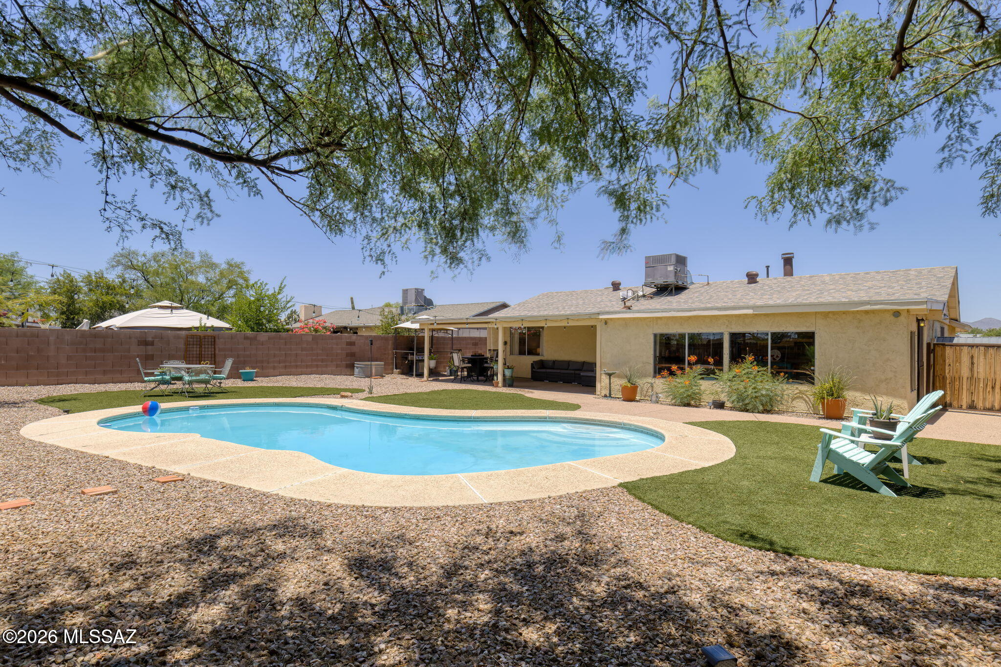 Why choose between a move-in ready home and a backyard you'll actually use? Here, you get both!
Set on nearly a quarter-acre lot with no rear neighbors, this Northwest Tucson home offers the privacy, outdoor space, and amenities you've been looking for. The backyard is the highlight, fully landscaped, a refreshing pool, an expansive covered patio, and plenty of room to entertain or relax. The Arizona room provides valuable flex space and opens directly to the backyard, creating seamless indoor-outdoor living. Inside, you'll find a functional floor plan with 3 bedrooms and 2 bathrooms, fresh interior paint, ceramic tile throughout the main living areas, and new carpet in the bedrooms. AND a new roof adds peace of mind and value. Conveniently located near shopping, dining, and everyday amenities, this move-in ready Northwest Tucson home combines privacy, space, and updates that are increasingly hard to find. If a great backyard tops your wish list, this home is one you won't want to miss.