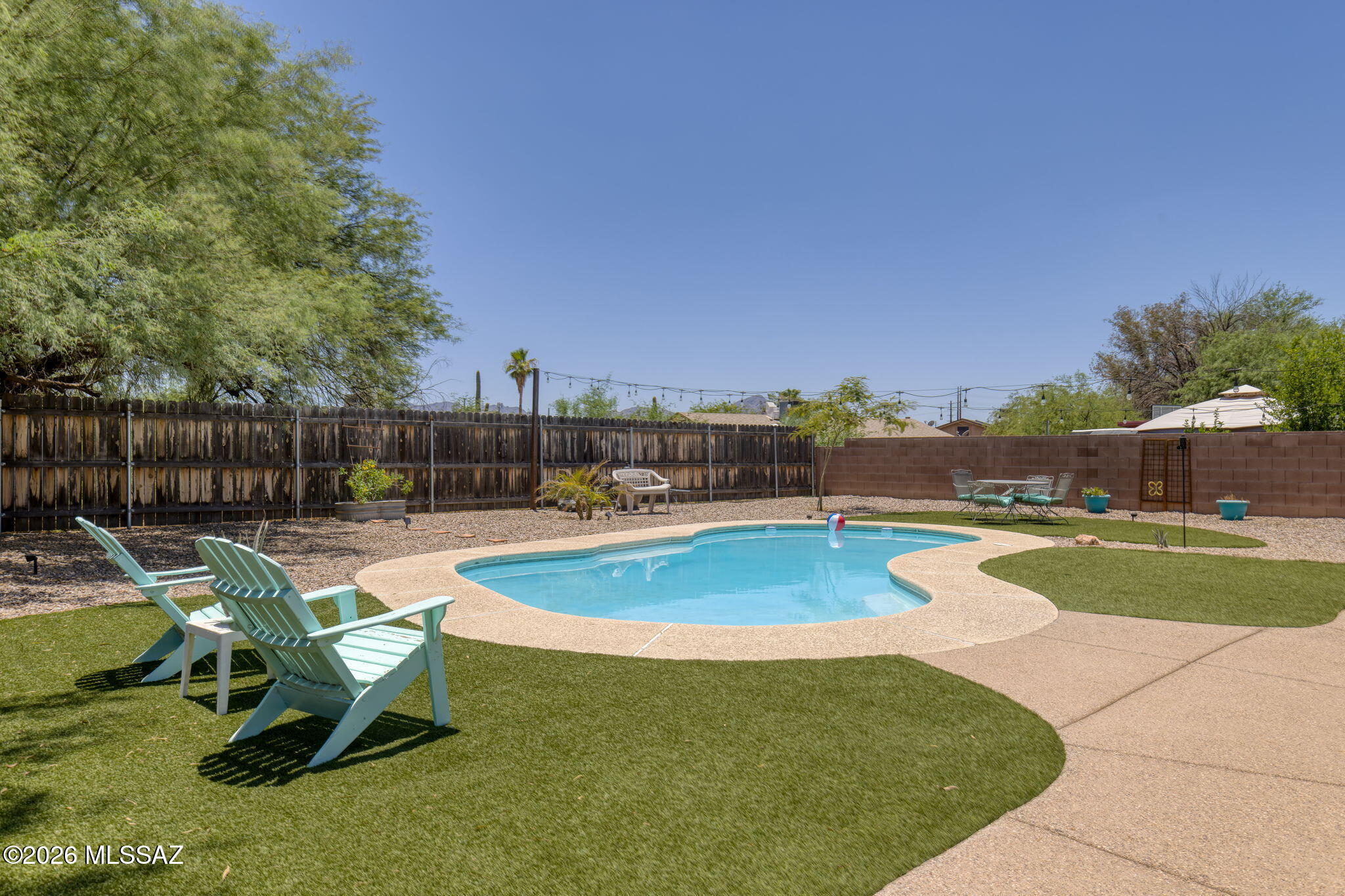 Why choose between a move-in ready home and a backyard you'll actually use? Here, you get both!
Set on nearly a quarter-acre lot with no rear neighbors, this Northwest Tucson home offers the privacy, outdoor space, and amenities you've been looking for. The backyard is the highlight, fully landscaped, a refreshing pool, an expansive covered patio, and plenty of room to entertain or relax. The Arizona room provides valuable flex space and opens directly to the backyard, creating seamless indoor-outdoor living. Inside, you'll find a functional floor plan with 3 bedrooms and 2 bathrooms, fresh interior paint, ceramic tile throughout the main living areas, and new carpet in the bedrooms. AND a new roof adds peace of mind and value. Conveniently located near shopping, dining, and everyday amenities, this move-in ready Northwest Tucson home combines privacy, space, and updates that are increasingly hard to find. If a great backyard tops your wish list, this home is one you won't want to miss.