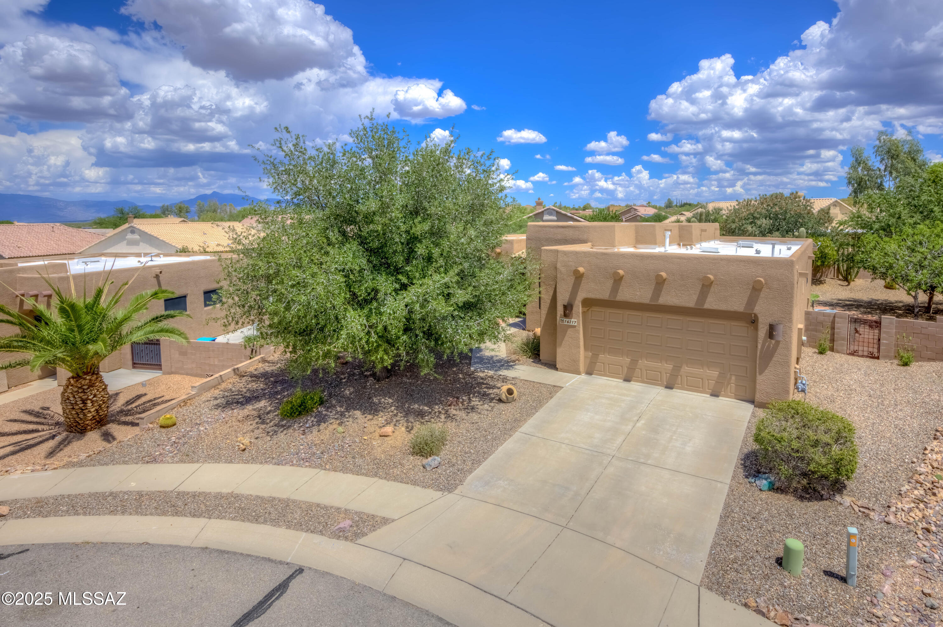 Located on a quiet cul-de-sac in the highly sought-after Vail School District, this beautifully maintained 3 bedroom, 2 bathroom home offers 1,845 sq ft of well-designed living space on nearly a quarter-acre lot, perfect for those who crave space, privacy, and scenic views. Inside, you'll find an open-concept layout with impressive 12-foot ceilings in the great room and ceramic tile floors throughout. The spacious kitchen is a standout with granite slab counters, a large island, gas cooktop, double ovens, cabinet pullouts, and a breakfast bar, all connected to the cozy dining area, ideal for both everyday living and entertaining. The LARGE master suite offers a peaceful retreat with a walk-in closet and a luxurious en-suite bath featuring double vanities with vessel sinks. The hall bathroom echoes the same upscale finishes with granite counters, vessel sinks, decorative mirrors, and upgraded lighting. Additional hallway cabinets and countertop space provide convenient extra storage. Step outside to an extended covered flagstone patio, a serene space to enjoy your morning coffee or evening gatherings while soaking in the breathtaking views of the Santa Rita Mountains. The private backyard includes a play structure and plenty of space to make your own, while the front courtyard with built in seating is the perfect place to take in the amazing Arizona sunsets. Additional highlights include security screens, exterior paint within the year, a water softener, and thoughtful design touches throughout.