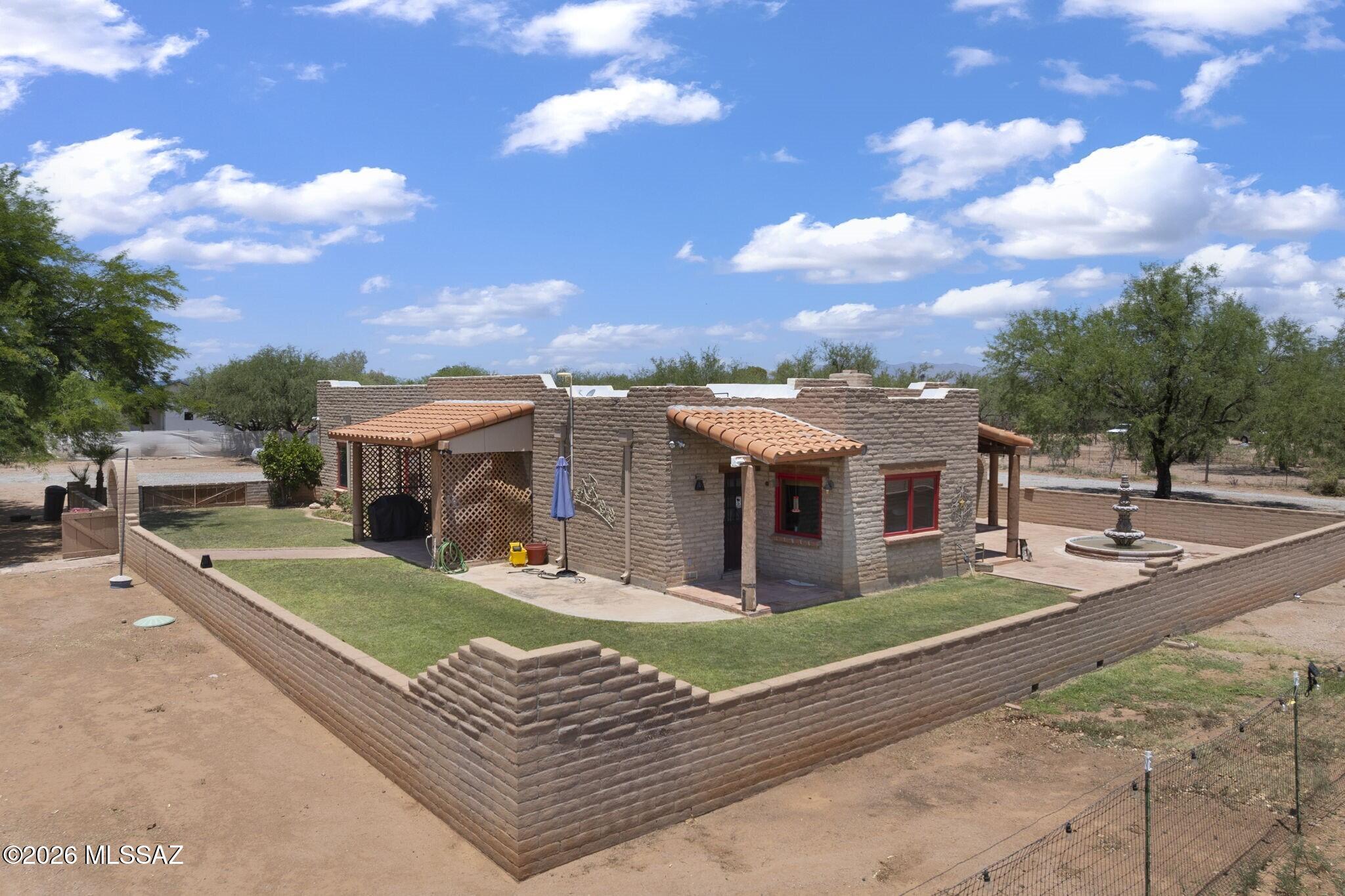 Set on 2.5 scenic acres with panoramic views and no HOA, this 3-bedroom, 2-bath equestrian property offers the freedom, privacy, and wide-open spaces you're craving. Corral, tack room and fenced pasture provide everything you need for your horses, with plenty of ways to expand or customize. The home has been designed with both comfort and function in mind, blending Southwestern character with room to unwind. Saltillo tile floors, exposed wood beams and brickwork, and a dramatic fireplace create a welcoming atmosphere; expansive windows frame the surrounding mountains, filling the home with natural light. Spacious kitchen is perfect for quiet mornings or gathering with friends after a day outdoors, while an expansive courtyard offers an ideal setting for al fresco entertaining.