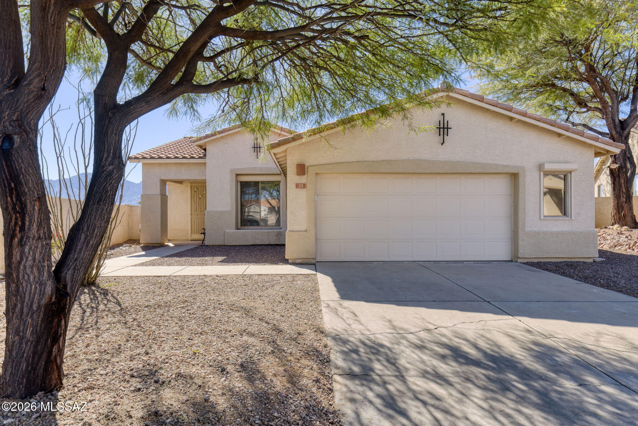 Located in a gated community, this home enjoys a natural desert buffer behind the property for added privacy and scenic views.

Situated within the 7,600-acre master-planned community of Rancho Vistoso, the home is surrounded by exceptional outdoor amenities. 

Enjoy 30+ miles of trails, the 202-acre Vistoso Trails Nature Preserve and Trailhead just across the street, and Honey Bee Canyon Park directly behind the community, offering more than 60 acres of parks, trails, and recreational amenities - many within walking distance.

Recently recognized as ''One of the most livable places to retire in the West,'' Oro Valley offers a premier lifestyle with stunning Catalina Mountain views, expansive Sonoran Desert landscapes, and abundant outdoor recreation, including numerous parks, hiking and biking trails, and golf courses.

This single-story home features high ceilings, 3 bedrooms (or 2 bedrooms plus a den), and 2 bathrooms. The interior has been freshly painted and is move-in ready. The refrigerator, washer, and dryer are included, along with a new dishwasher. Security shutters on the windows provide convenience and peace of mind for a true "lock-and-leave" lifestyle.

Enjoy the screened-in patio, perfect for relaxing outdoors while taking in Catalina Mountain views and the low-maintenance desert landscaping with mature trees.

This property presents a wonderful opportunity to experience the serene desert lifestyle and remarkable setting that define Oro Valley living.