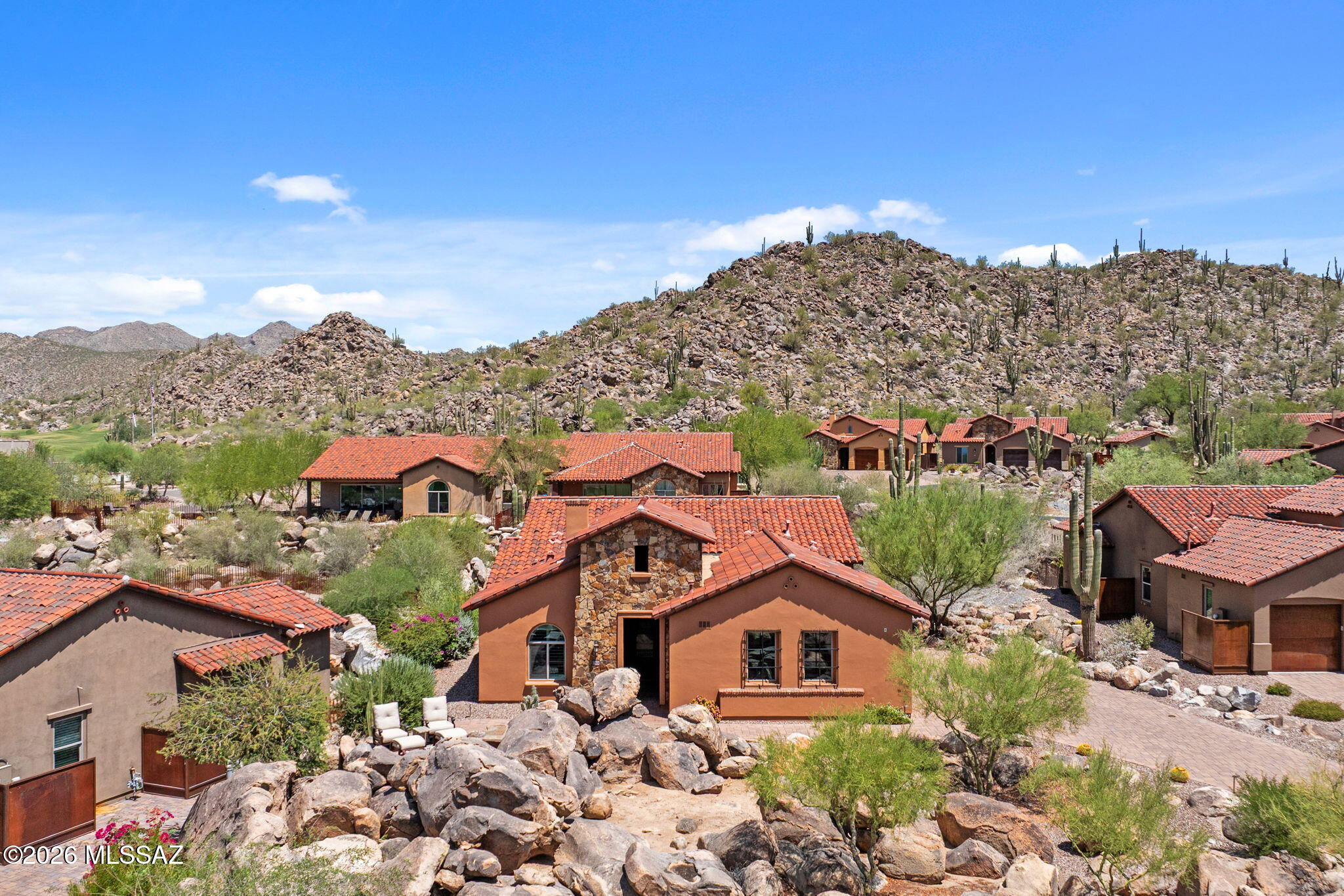 Nestled among the iconic boulder outcroppings that define Stone Canyon, this exceptional golf casita offers a rare combination of privacy, luxury, and breathtaking desert beauty. Perfectly positioned to capture sweeping views of both the Tortolita and Catalina Mountains, this home embraces the very best of Arizona's indoor-outdoor lifestyle. Designed for entertaining and relaxation, the outdoor living spaces are truly exceptional. Multiple patios invite you to unwind while enjoying spectacular sunsets, enhanced by two custom gabion gas fire features, two custom water features, a built-in outdoor BBQ, custom fencing for added privacy, motorized drop-down screens, and a premium Frankford umbrella, creating comfortable outdoor living spaces throughout the day and evening. A custom (continued) First Impressions front door welcomes you into the beautifully appointed 1,942-square-foot residence. Inside, you'll find three spacious bedrooms, each with its own en-suite bath, thoughtfully designed with a sophisticated, neutral palette inspired by the surrounding Sonoran Desert. The gourmet kitchen combines style and functionality with Bosch appliances, soft-close cabinetry, pull-out drawers, and generous workspace, making it ideal for both everyday living and entertaining. With more than $100,000 in premium upgrades, this home is truly move-in ready. Highlights include plantation shutters and custom window coverings throughout, a whole-home water softener, new carpet in the primary suite, a NEMA outlet for convenient electric vehicle charging, and a freshly painted exterior completed in Spring 2026. The Stone Canyon Golf Casitas are among the community's most sought-after residences thanks to their stunning setting and unmatched convenience. Enjoy an easy stroll to the clubhouse, restaurant, fitness center, and world-renowned golf course. Located within the prestigious, guard-gated Stone Canyon community, residents enjoy one of Arizona's premier private golf experiences. Consistently ranked among Arizona's top three golf courses and one of the Top 100 Residential Golf Courses in the United States, Stone Canyon offers an extraordinary lifestyle where luxury, privacy, championship golf, and spectacular desert scenery come together. Whether you're seeking a full-time residence or a lock-and-leave retreat, this exceptional casita offers the perfect blend of elegance, comfort, and resort-style living in one of the Southwest's most coveted communities.