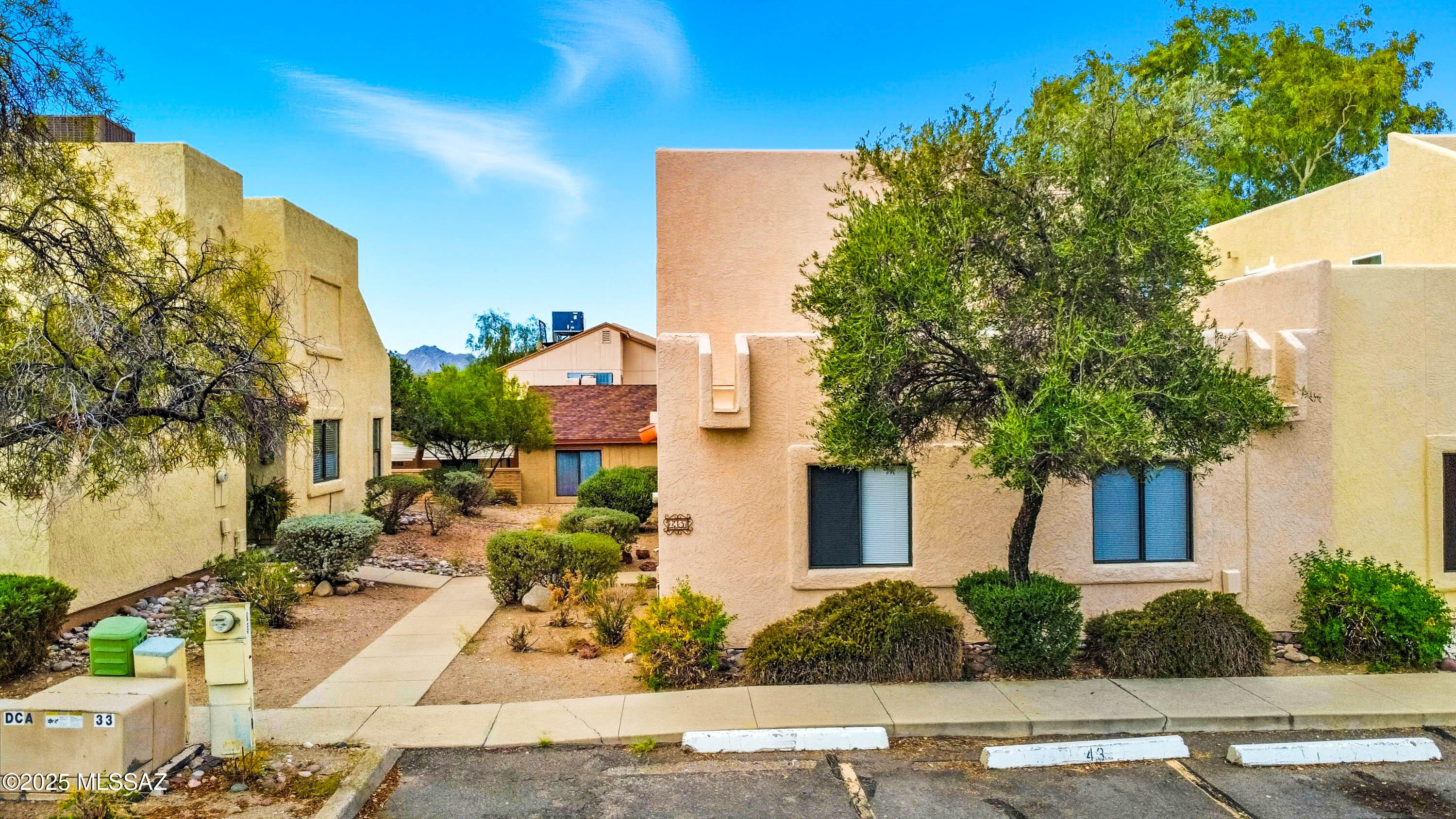 Welcome to Casitas De Palo Santo - quiet, gated townhouse community with convenient access to I-10, located just minutes from the University of Arizona and downtown. This two-story, 3 bed / 2 bath, over 1,500 sq. ft. townhouse is the largest, sought-after floor plan in the community, rarely available on the market. End unit with more privacy, lots of windows, plenty of natural light, new window covers and light fixtures throughout. Freshly painted interior with newer laminate flooring on the first floor, brand new carpet in two downstairs bedrooms and new vinyl floor on the stairs and in the primary bedroom on the second floor. Kitchen has plenty of cabinets, including matching built-in cabinet in the dining area, lots of counter space, newer refrigerator, brand new stainless steel range dishwasher and disposal. Striking, two story high living room has a wood burning fireplace, wet bar and access to covered patio and small, private backyard. Hallway bathroom located next to the two bedrooms on the first floor has all new fixtures. Spacious primary bedroom on the second floor has a private bathroom (also with new fixtures) and a balcony with Tucson Mountains and sunset views. New washer and dryer convey with the house. The HVAC is just about 6 - 7 years old and has been regularly serviced. The unit has two parking spaces, one covered (carport) and one uncovered. The HOA covers water, sewer, trash, gate, pool, spa, streets, parking and grounds. The townhouse can be a wonderful primary residence, winter home or a fabulous investment property. It has been a successful rental for nearly 2 decades. One year lease signed on November 1, 2025. Monthly rent is $1,495.