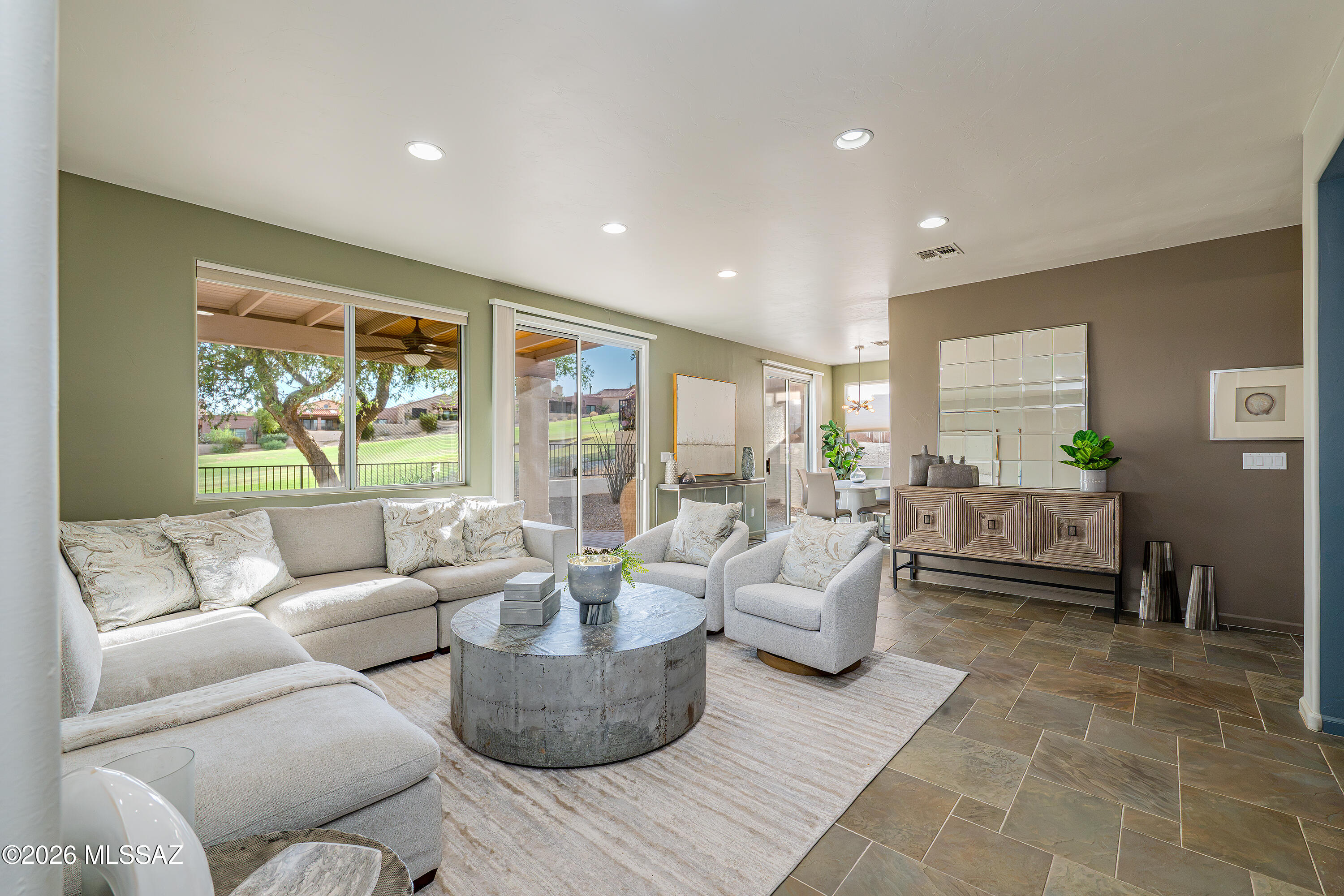 Rare Opportunity on the 15th Fairway of Tucson National's Sonoran Course. This beautifully updated single-family homes captures  sweeping golf course, mountain, and sunset views from one of the community's most desirable neighborhoods.   This 2-bedroom, 2-bath residence offers 1,560 square feet of thoughtfully designed living space with no interior steps.

A grand entry foyer welcomes you into the spacious living area, where expansive windows frame the stunning views beyond. The well-appointed kitchen features soapstone countertops, while soft-close shaker cabinetry provides ample storage. Multiple dining areas, a versatile flex room, and a split-bedroom floor plan provide flexibility for entertaining, working from home, or hosting guests.

Designed for both comfort and outdoor enjoyment, the home features a covered patio, private front courtyard, and oversized two-car garage. The backyard is a true retreat, complete with a putting green, mature landscaping, and unobstructed golf course views.

Extensively remodeled since its last sale, this home offers valuable updates and peace of mind, including a newer roof (October 2024), updated HVAC systems, and complete exterior repainting in 2022.

Ideally located near premier shopping, dining, recreation, and medical facilities, this exceptional property blends comfort, convenience, and scenic beauty. Whether you're searching for a full-time residence or a seasonal retreat, this home delivers the best of resort-style living in one of Northwest Tucson's most sought-after golf course communities.