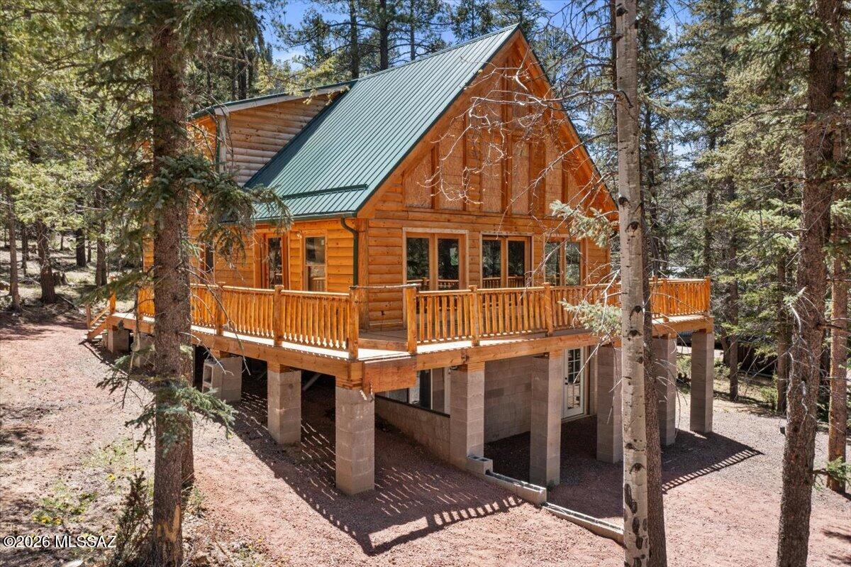Unfinished log cabin in the sought-after Talwiwi neighborhood, located approximately 5 miles north of Alpine, AZ. Set on a beautifully treed 1.03-acre lot with views of the lake and surrounding meadow, this property offers a rare opportunity to create your own mountain retreat exactly the way you want it. Built in 2023 and approximately 70% complete, this 2,800 sq ft chalet style cabin features a stunning wall of windows and soaring cathedral ceilings that bring in natural light and showcase the surrounding scenery. The main level includes an open kitchen, dining, and great room, along with two bedrooms, a full bath, and laundry. Upstairs offers a spacious primary suite and a separate loft-style office or study overlooking the main living area. The home also includes an unfinished 1,100 sq ft walkout basement with 9' ceilings already plumbed for a full bath, laundry, and kitchen sink--offering excellent potential
for a separate living space, guest quarters, or rental setup.
Additional features include approximately 500 sq ft of decking, a durable 26-gauge metal roof, neighborhood water system supplied by underground springs (approximately $420 annually), standard septic system, Frontier WiFi/phone availability, and a fire
hydrant located nearby. Plumbing has been roughed in, and a 400-amp electrical panel is installed with partial wiring completed.
Whether you're looking to finish a full-time home, second home, or investment property, this is a unique opportunity to step into a newer build and bring your own vision to life in the White Mountains. Owner may carry with 25% down. Property is being sold as-is.
